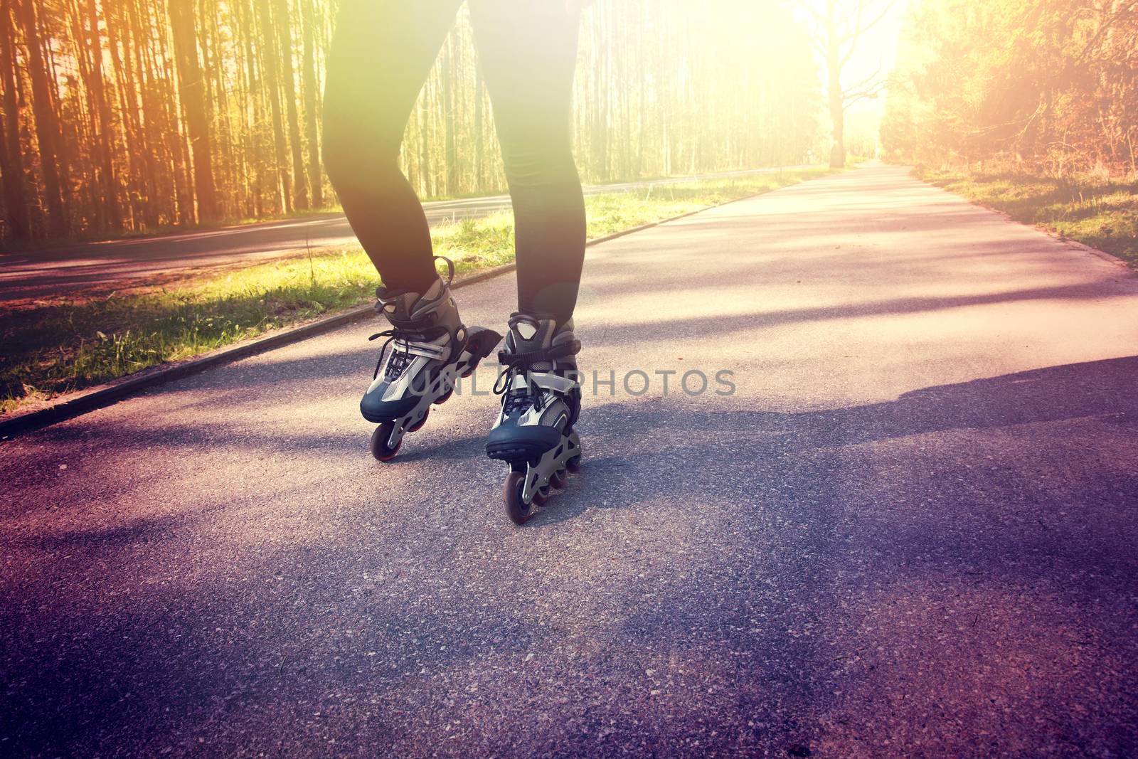 Teenage girl on roller skates at summer. Inline skates sport conceptual image.