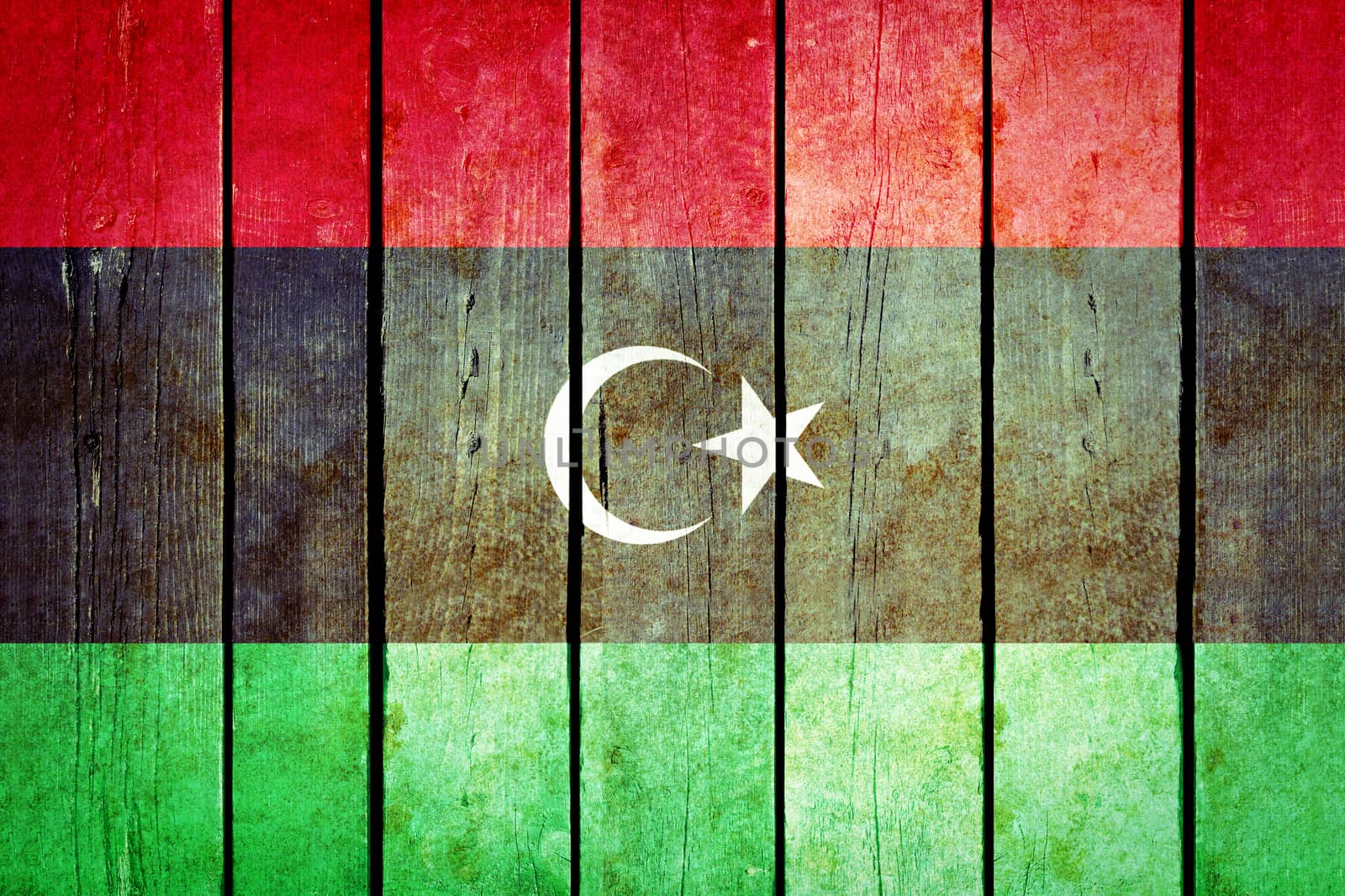 Libya wooden grunge flag. Libya flag painted on the old wooden planks. Vintage retro picture from my collection of flags.