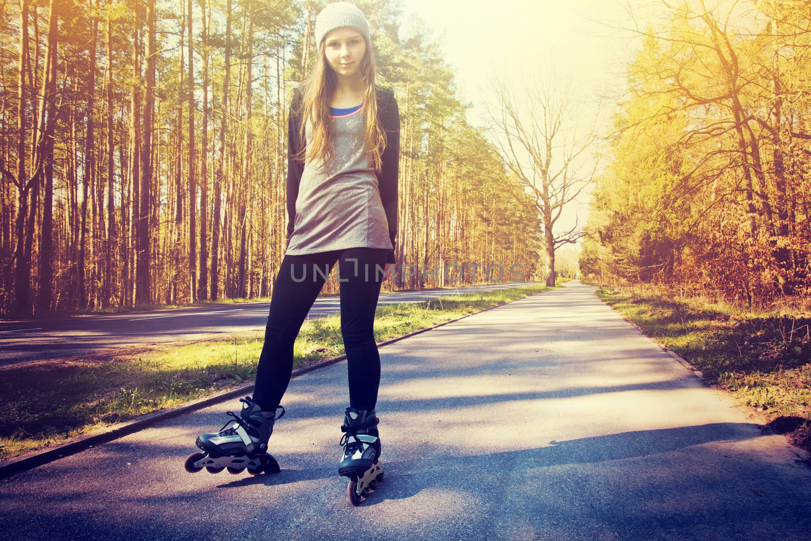 Teenage girl on roller skates at summer. Inline skates sport conceptual image. Vintage retro colors picture.