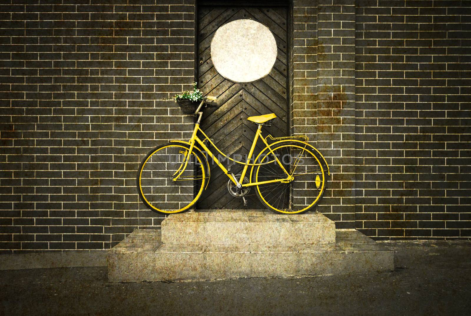 Vintage retro old yellow bike on the street. Grunge retro stylized picture.