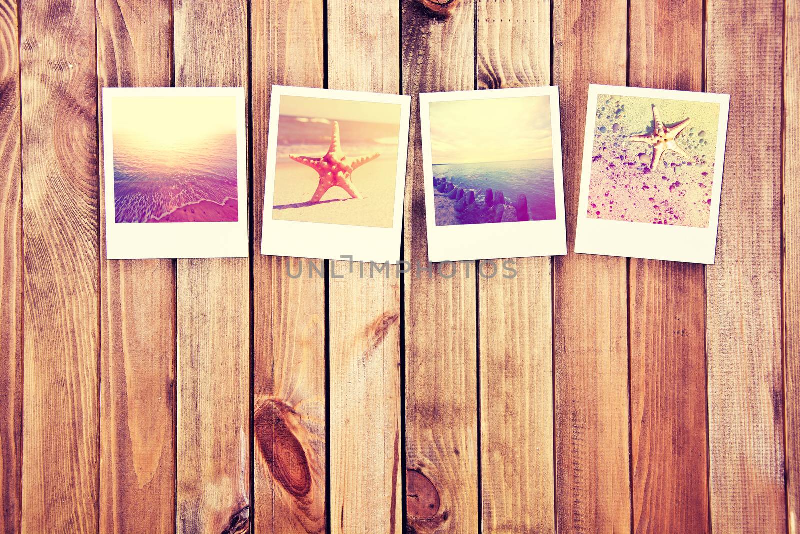 Great memory from vacation. Instant photos frames on wooden background.