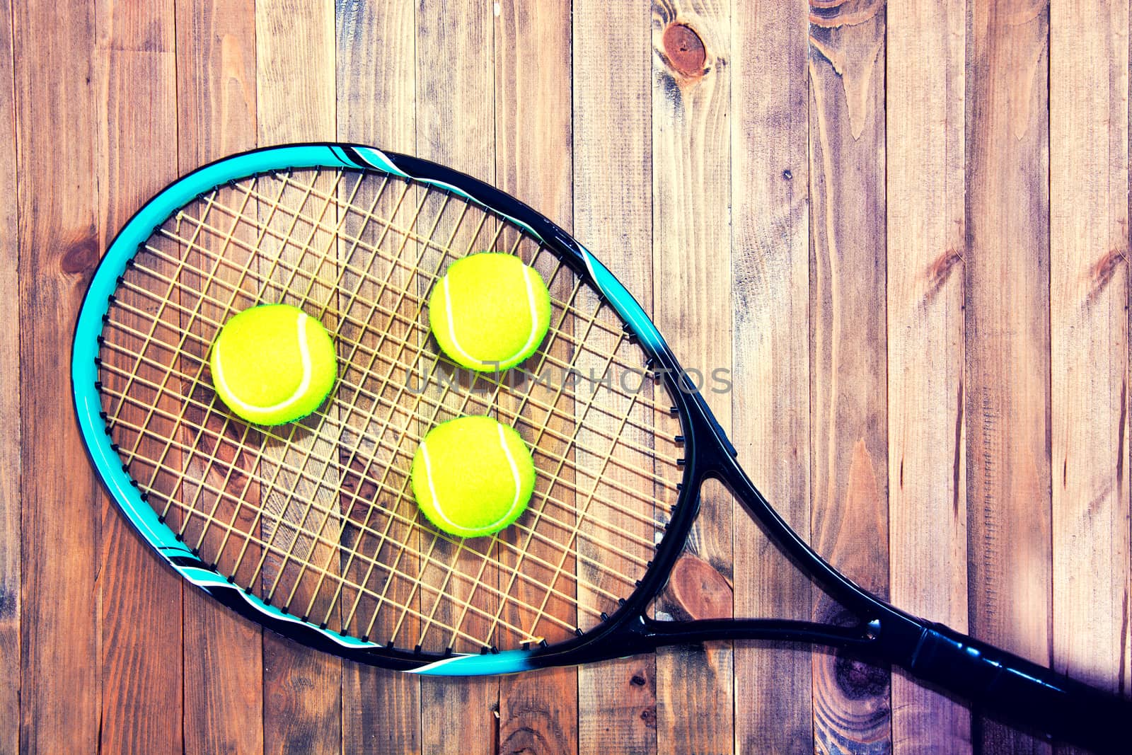 Tennis game. Tennis ball on wooden background. Vintage retro picture.