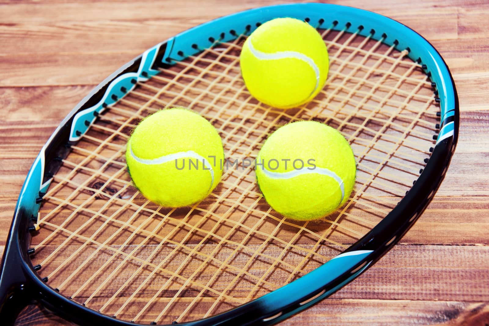 Tennis game. Tennis ball and racket on wooden background. Vintage retro picture.