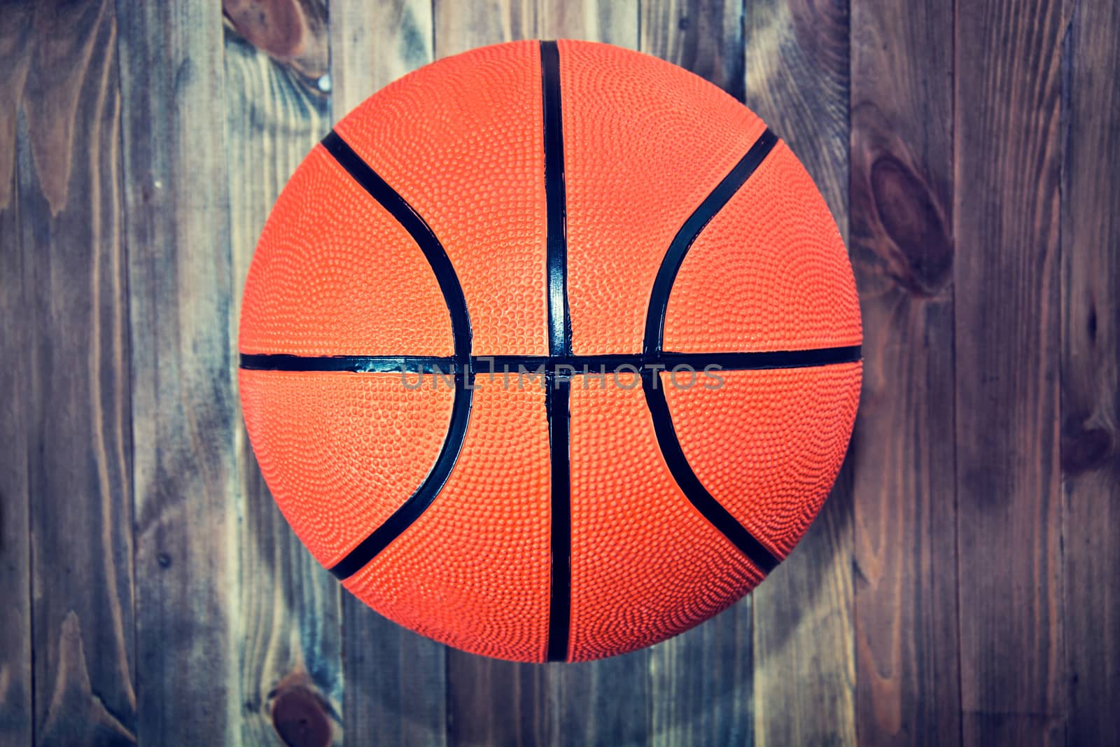 Basketball ball on wooden hardwood floor. by satariel