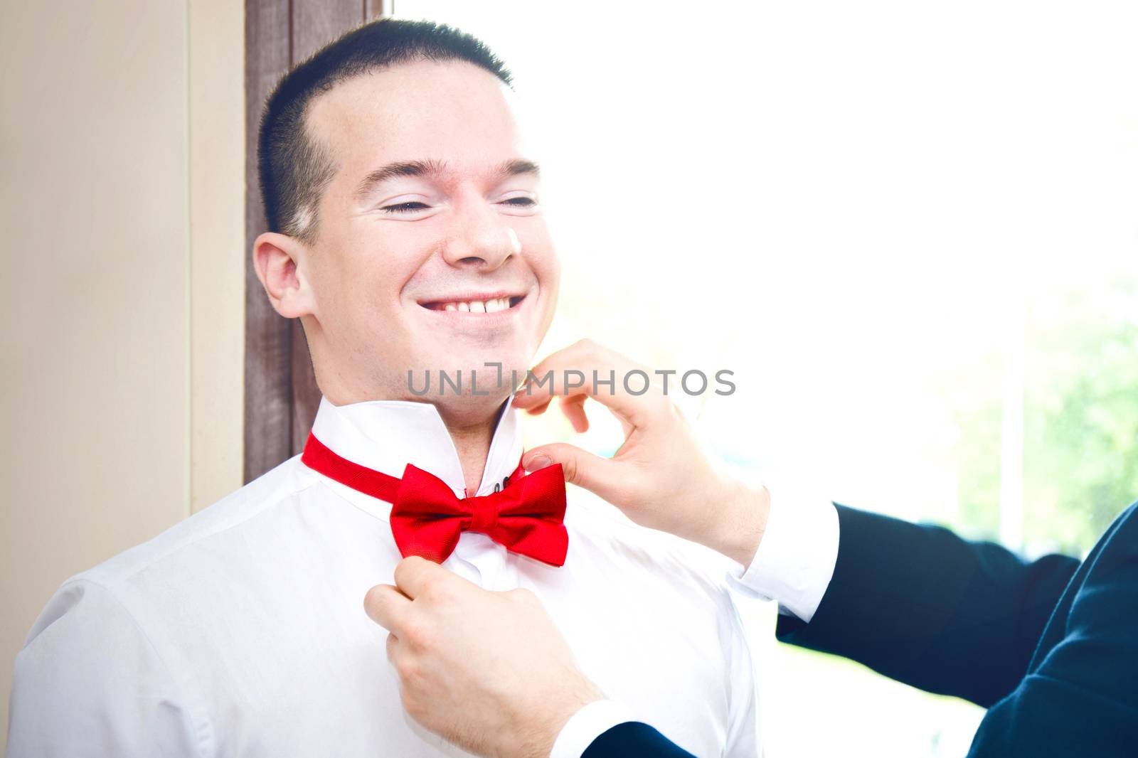 Groom prepared to get married by best man. Marriage and wedding concept image.