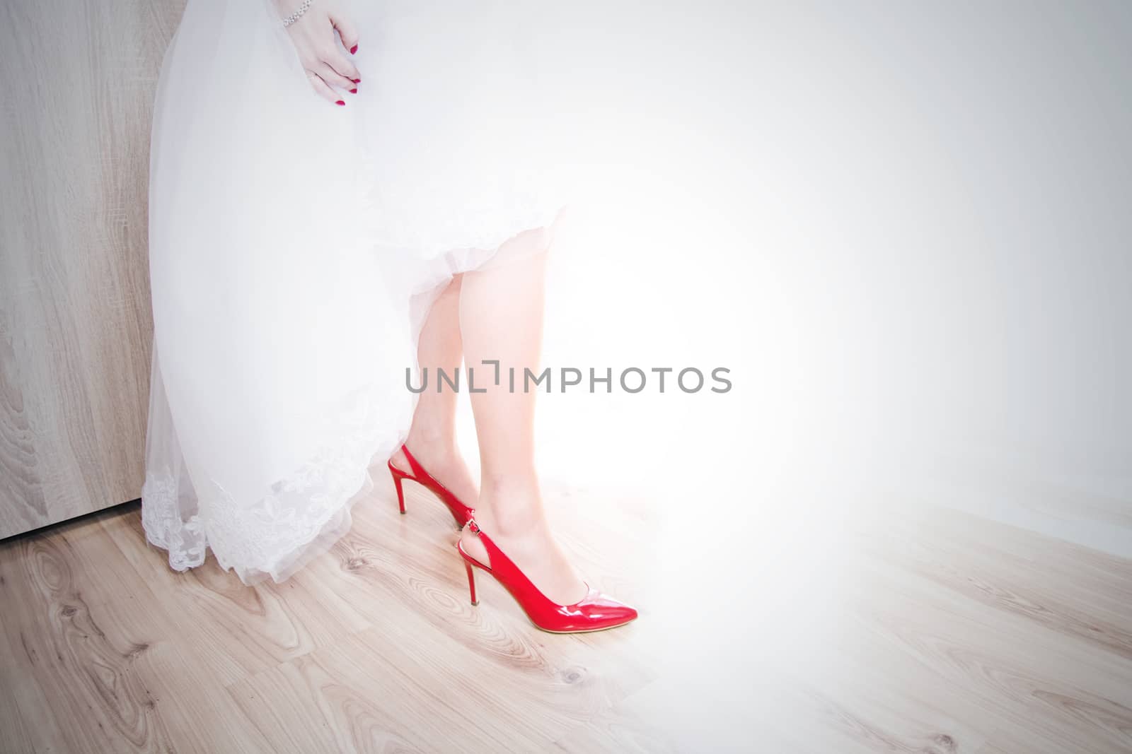 Bride in wedding dress and bridal shoes. Marriage and wedding concept image.