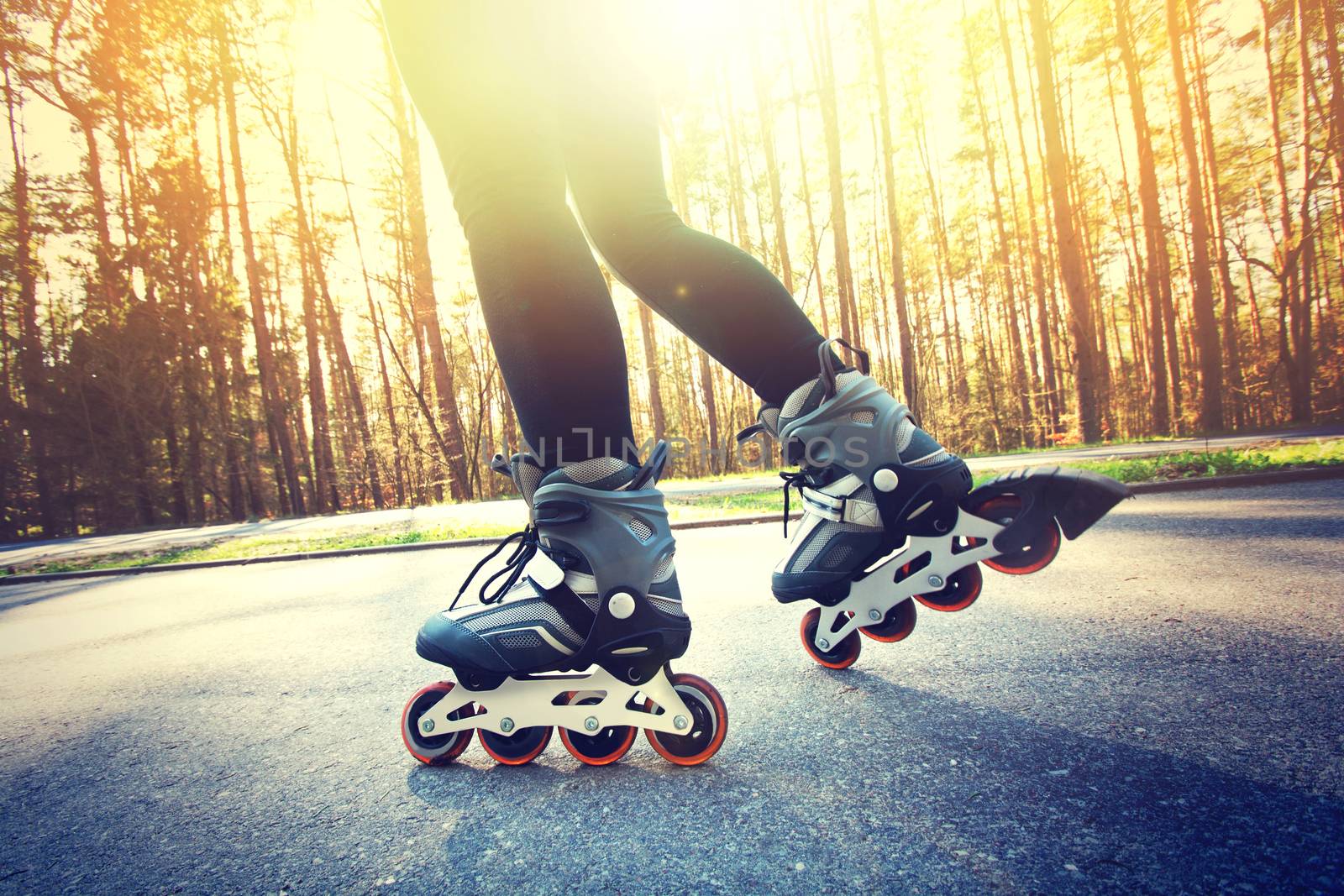 Teenage girl on roller skates at summer. Inline skates sport conceptual image.