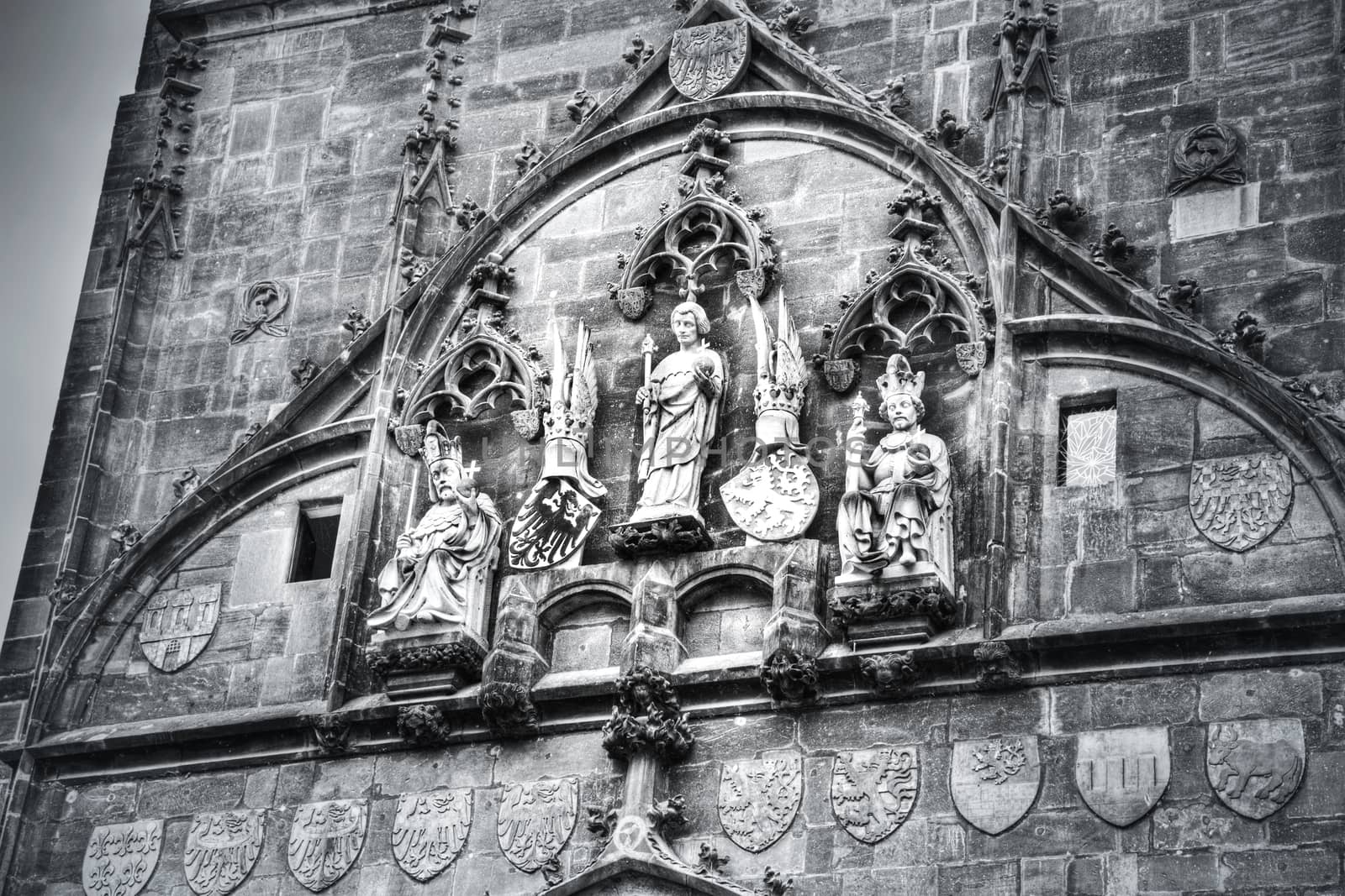 Charles Bridge gate in Prague. Statues on the gate. Black&white picture.