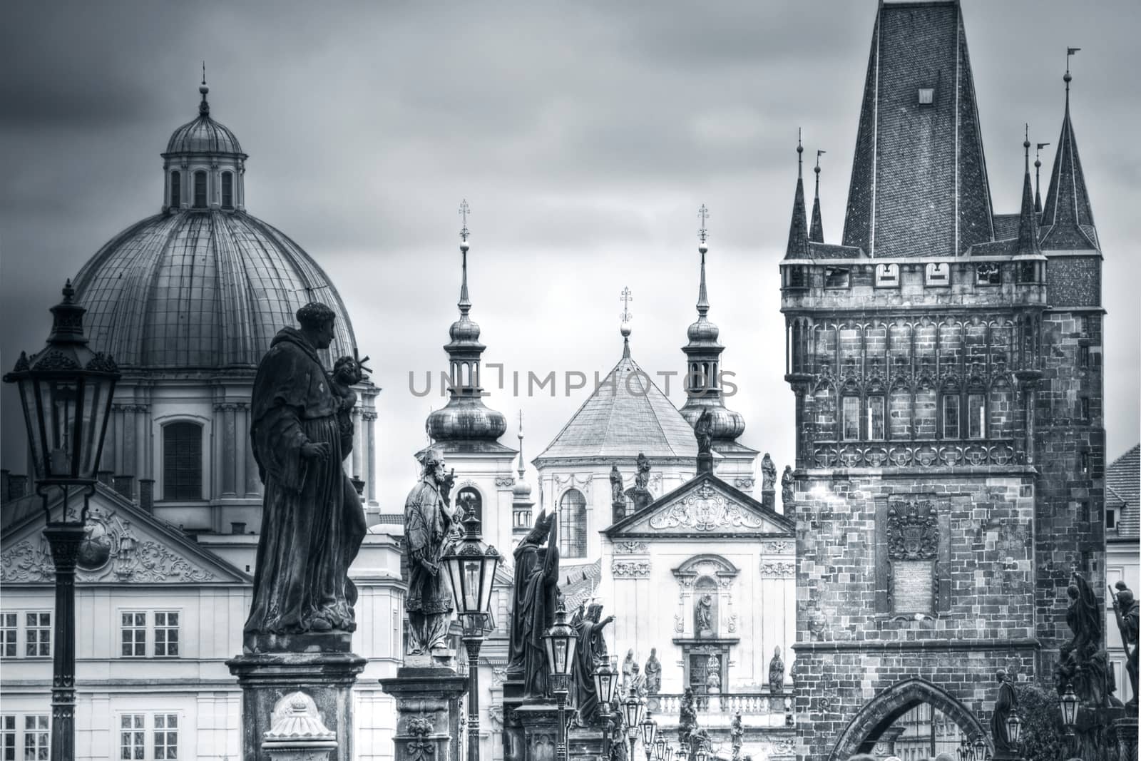 View of Charles Bridge and monuments in Prague, Europe. Black&white picture.