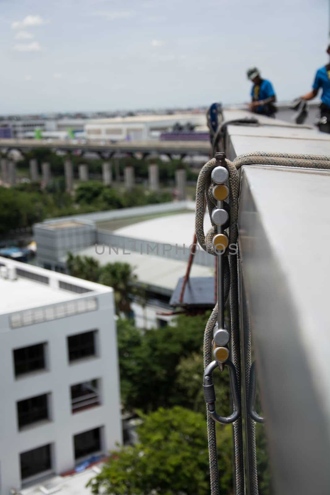 workers cleaning windows service on high rise building