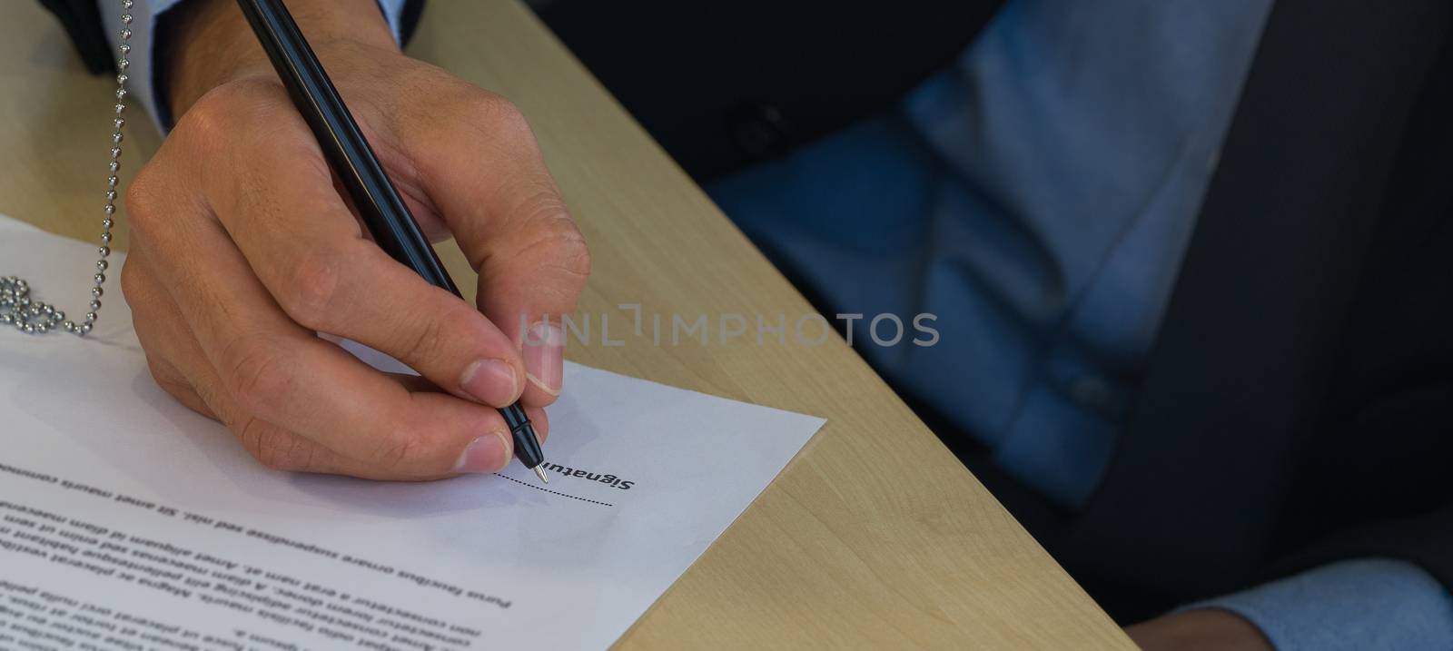 Job interviewers put a sign on the contract after being considered by the HR department by chadchai_k