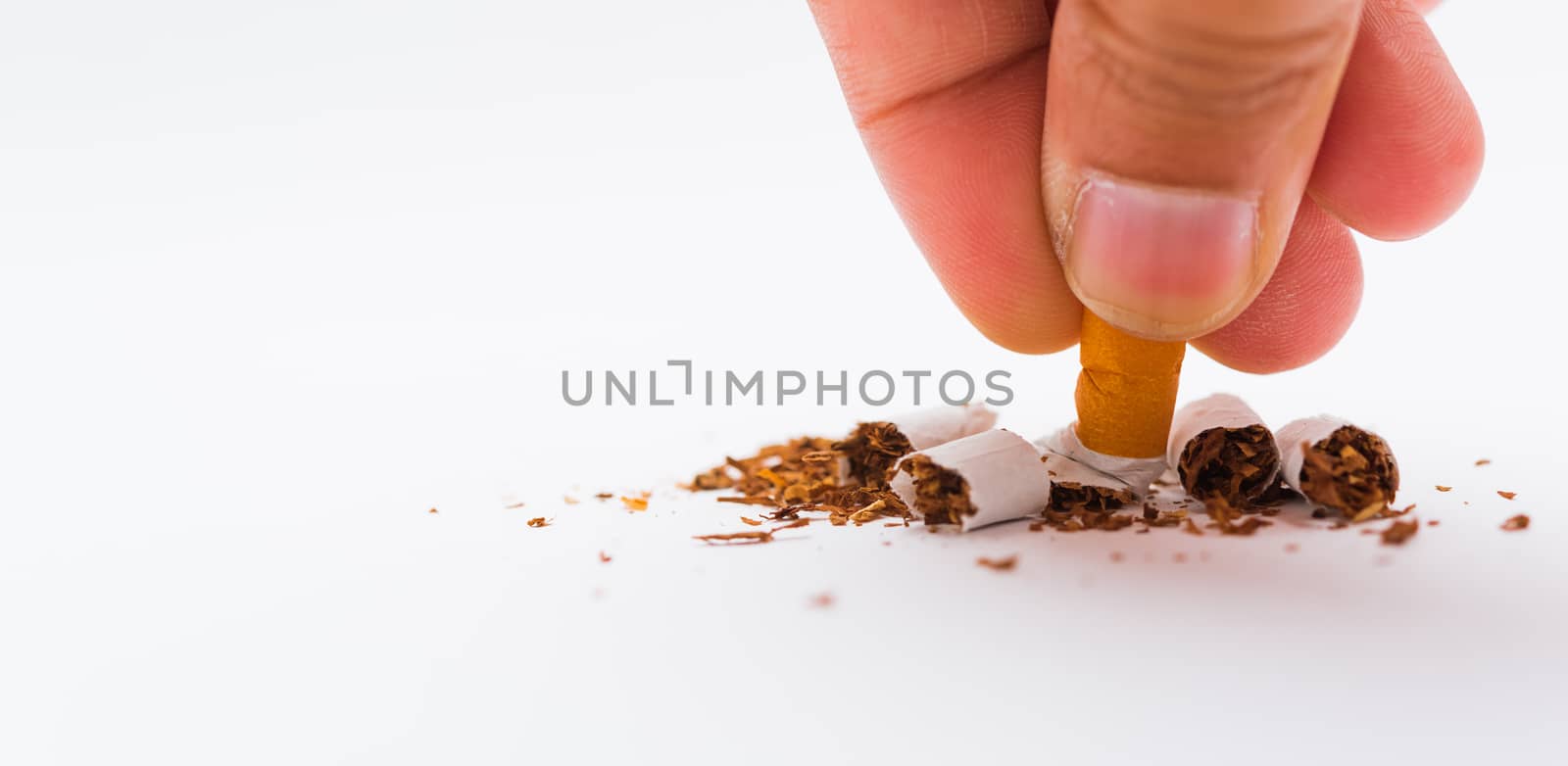 31 May of World No Tobacco Day, no smoking, close up of hand hold broken pile pin down or putting cigarette or tobacco on white background with copy space, and Warning lung health concept