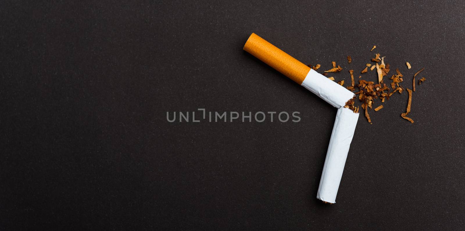 31 May of World No Tobacco Day, no smoking, close up of broken pile cigarette or tobacco STOP symbolic on black background with banner copy space, and Warning lung health concept