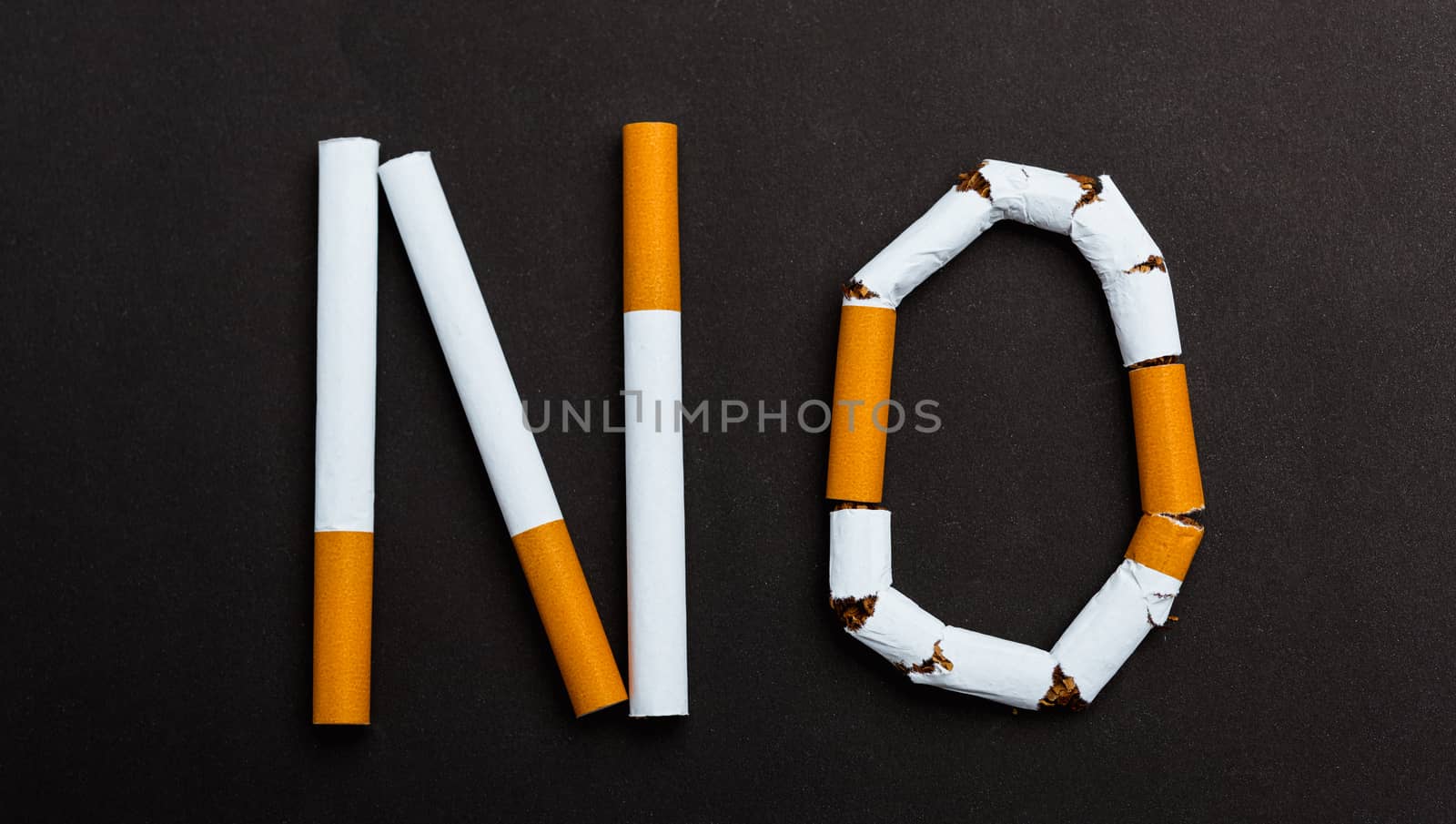 31 May of World No Tobacco Day, no smoking close up word NO spelled text of the pile cigarette or tobacco on black background with copy space, and Warning lung health concept