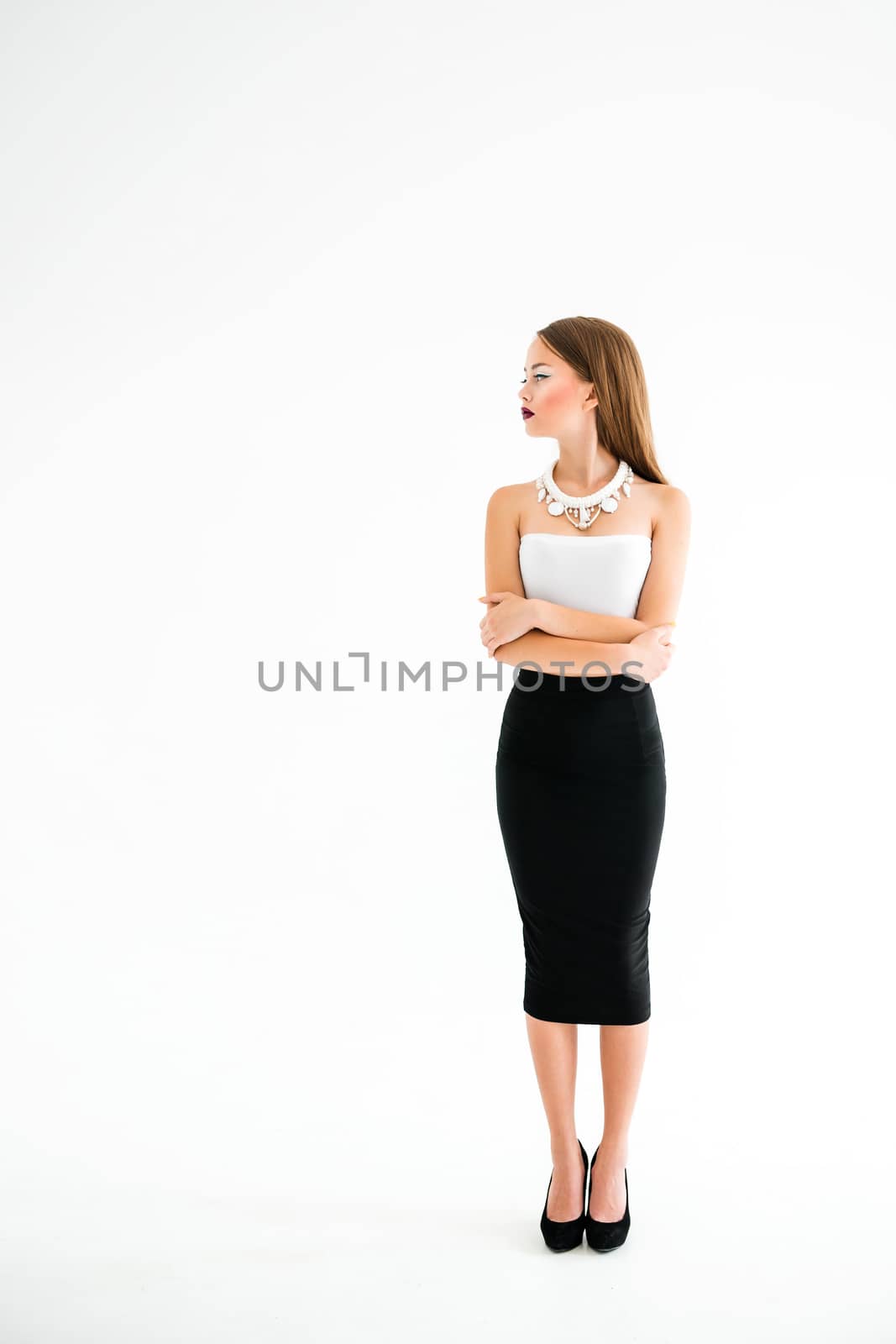 girl in a white blouse and black skirt on a white background