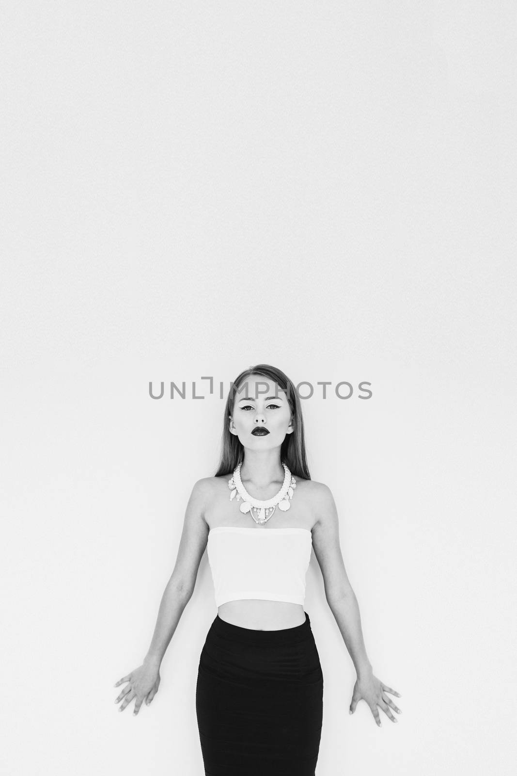 girl in a white blouse and black skirt on a white background