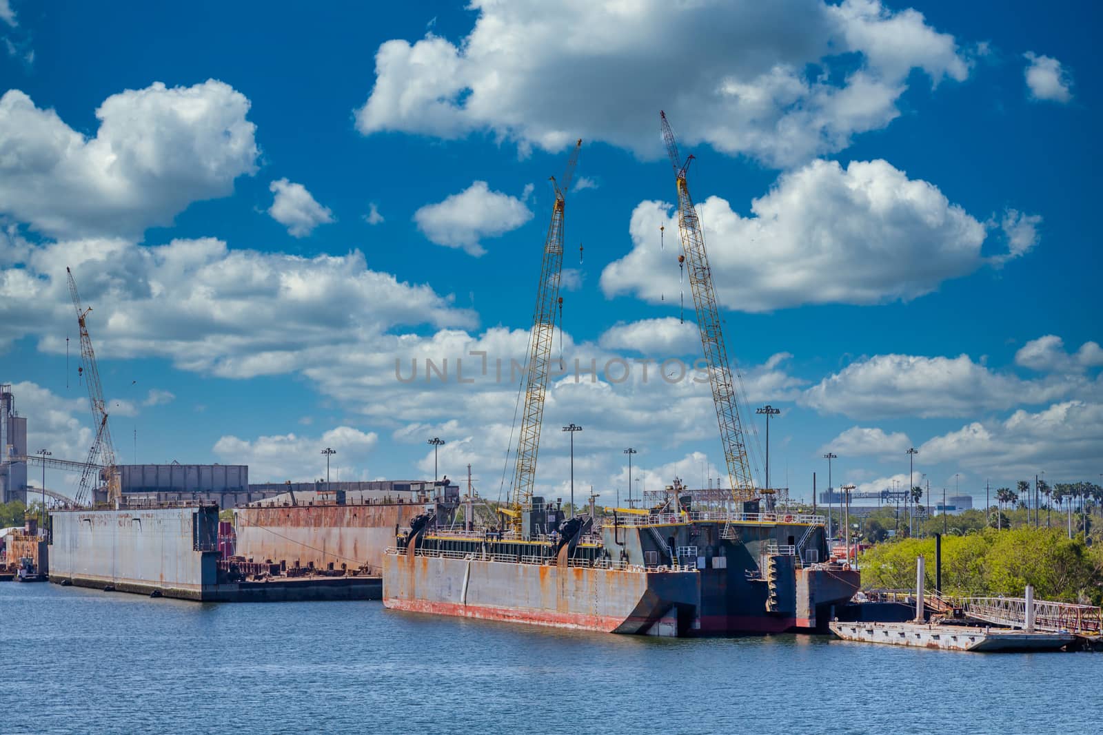 Construction cranes at a dry dock and shipyard