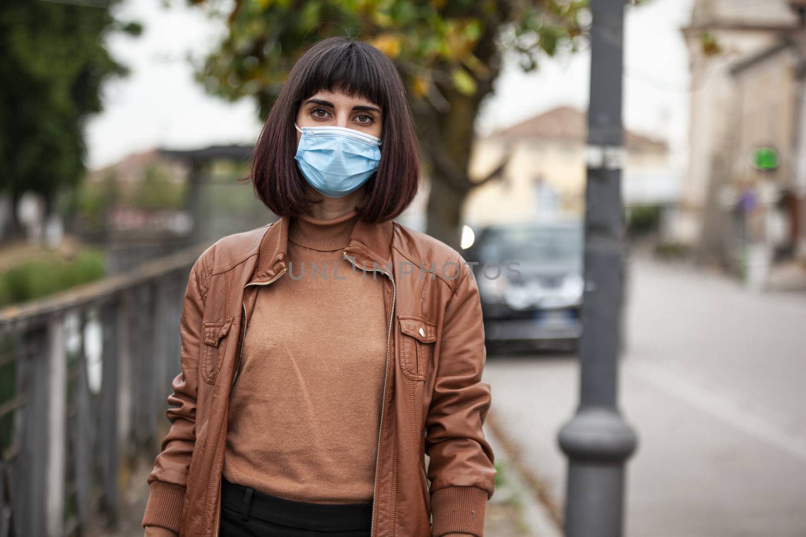 Portrait of a Girl with medical mask outdoor during covid quarantine in Italy