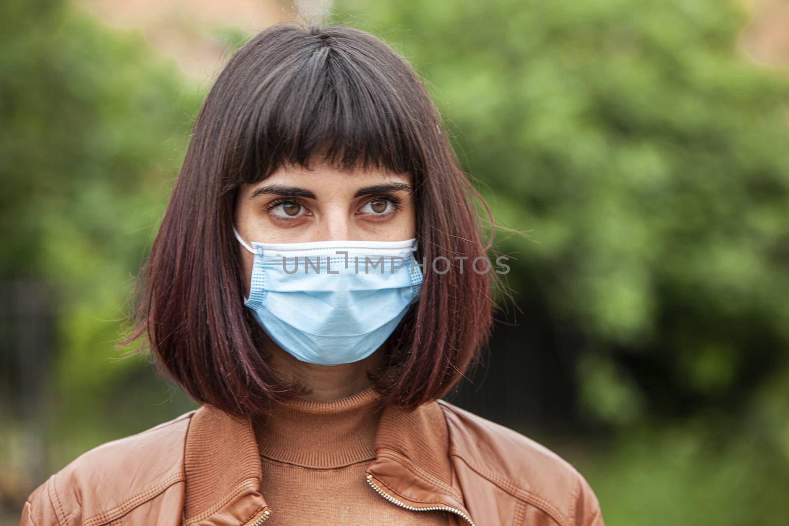 Close up Portrait of a Girl with medical mask outdoor during covid quarantine in Italy