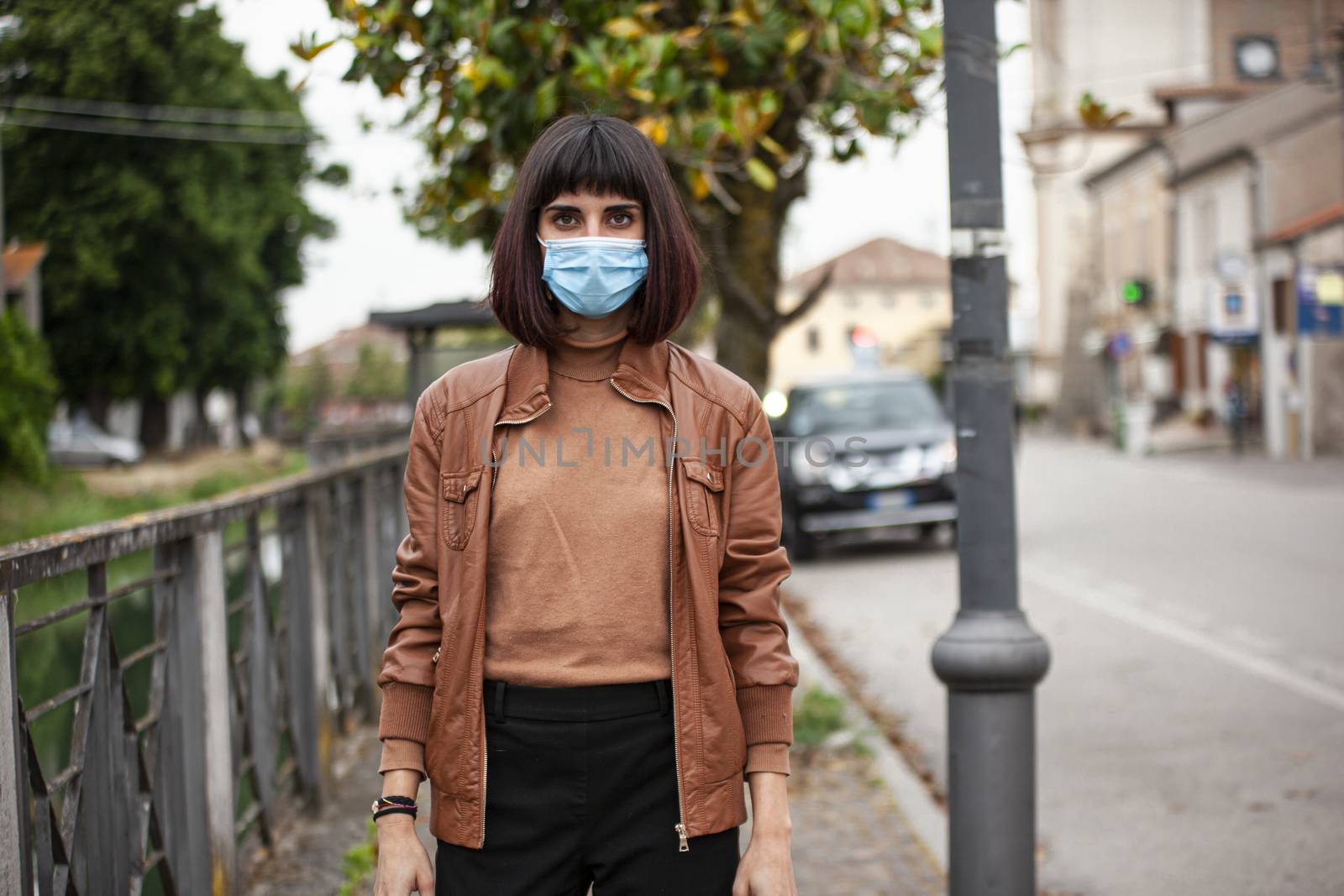 Portrait of a Girl with medical mask outdoor during covid quarantine in Italy