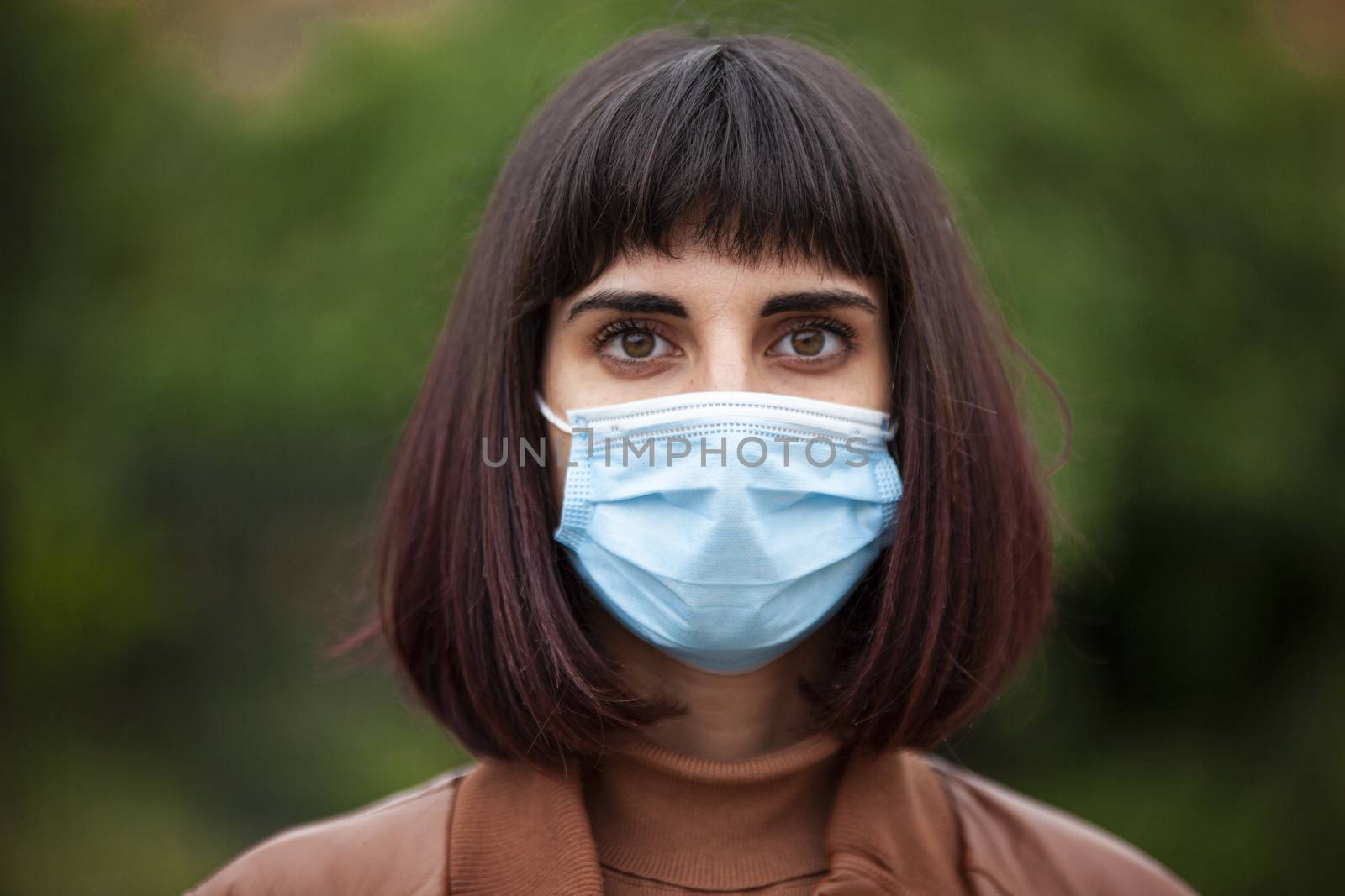 Close up Portrait of a Girl with medical mask outdoor during covid quarantine in Italy