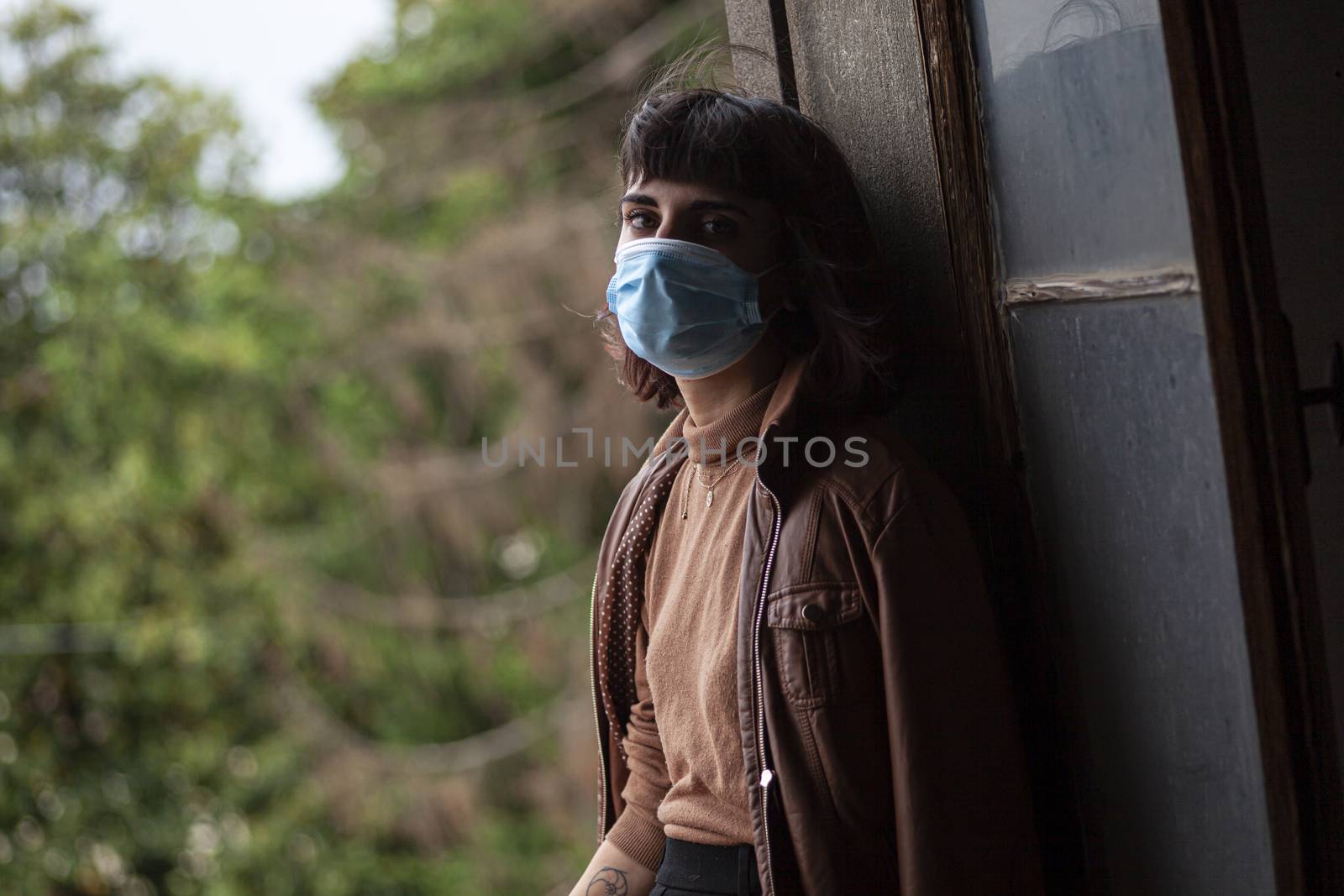 Girl with medical mask at window by pippocarlot
