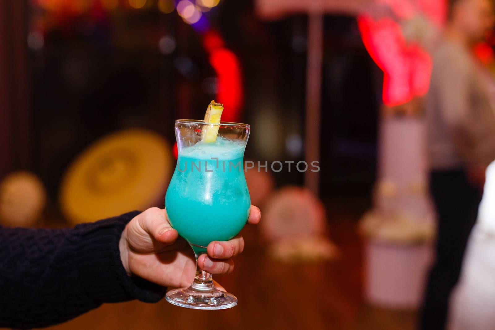 A hand holding a glass of wine. High quality photo
