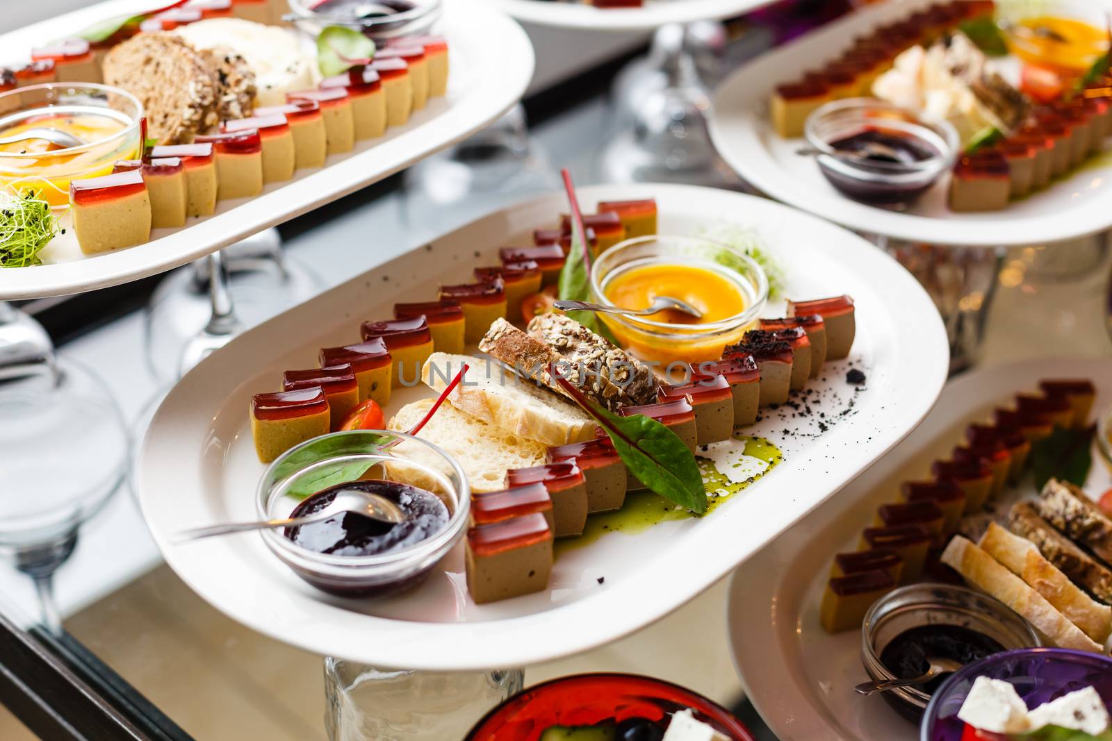 A group of people sitting at a table with a plate of food. High quality photo