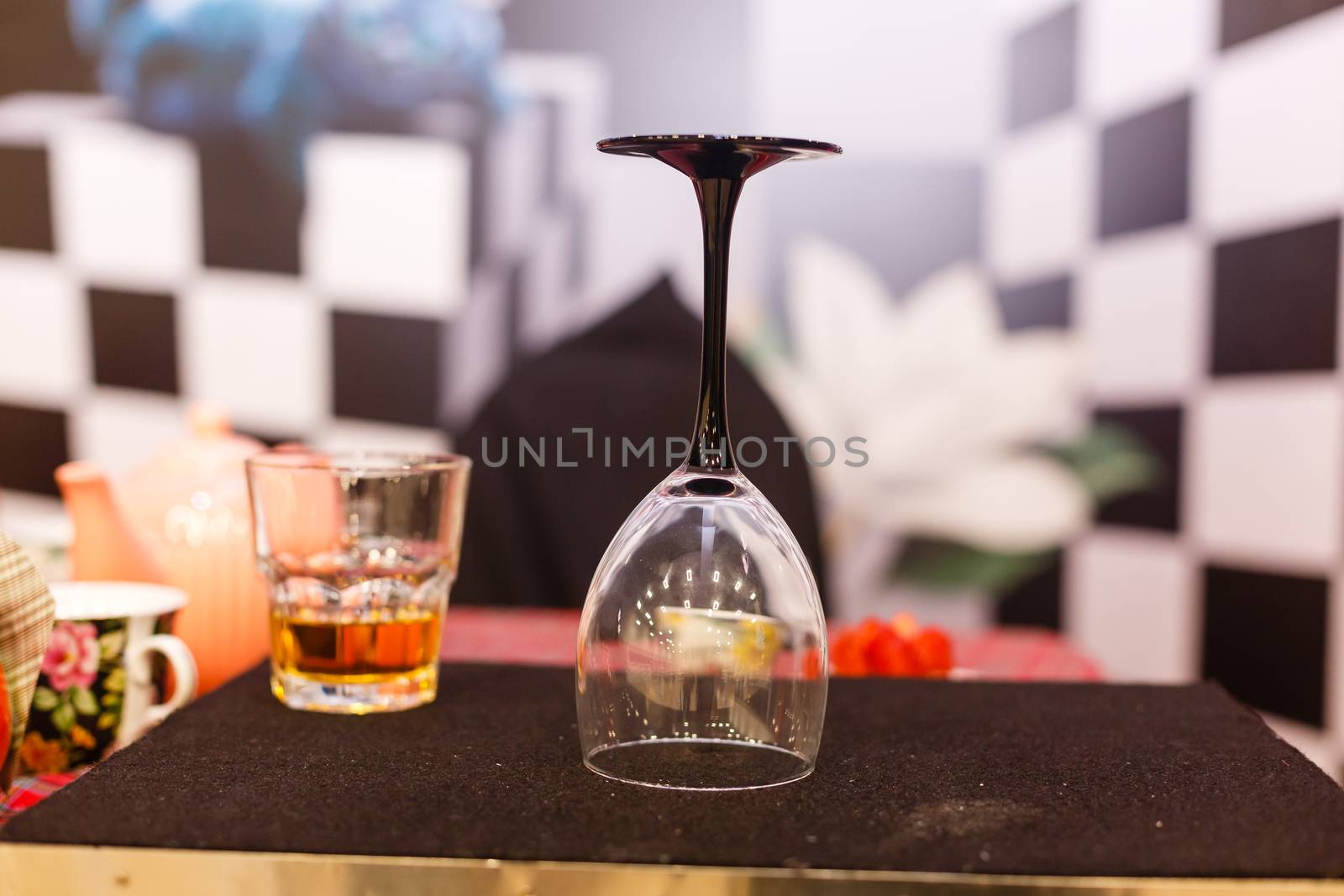 A close up of a wine glass on a table. High quality photo