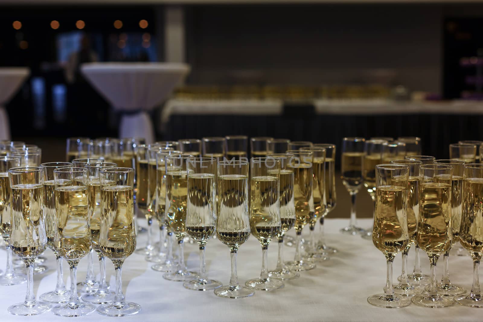 A group of glass bottles on a table with wine glasses. High quality photo