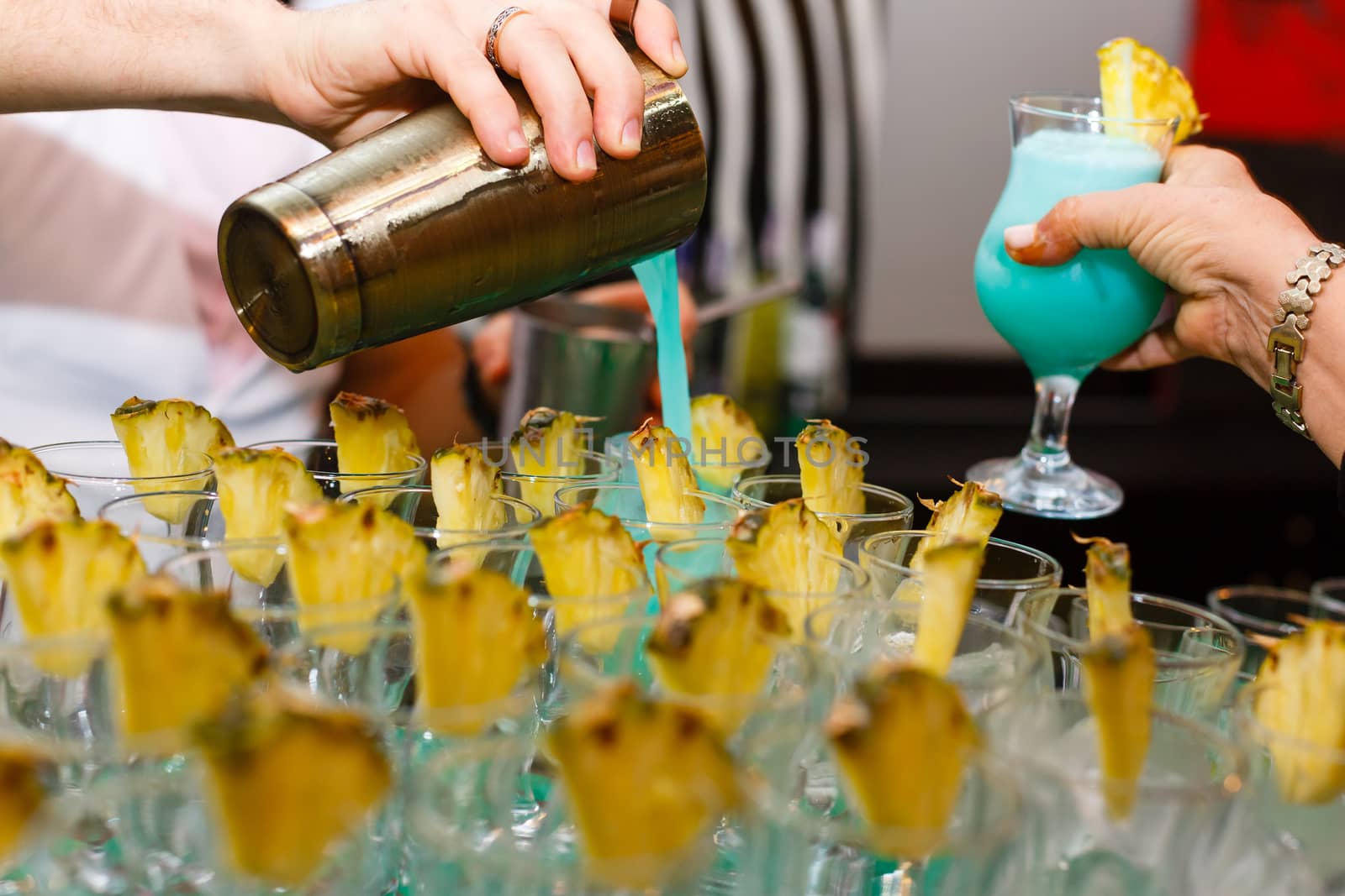 A person sitting at a table with wine glasses. High quality photo