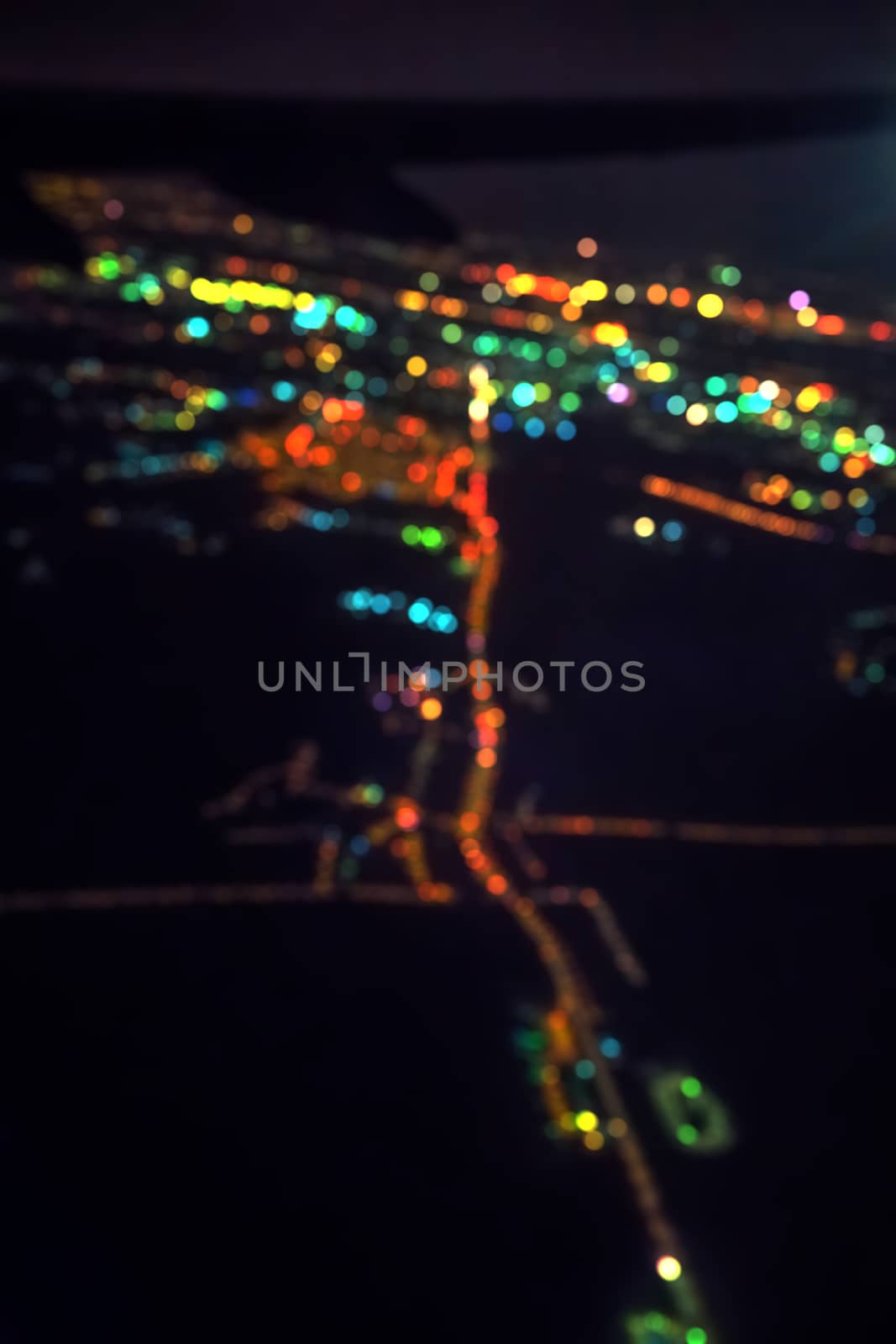 Dark background view of city with lights from aeroplane. Night lights in the city. by bonilook
