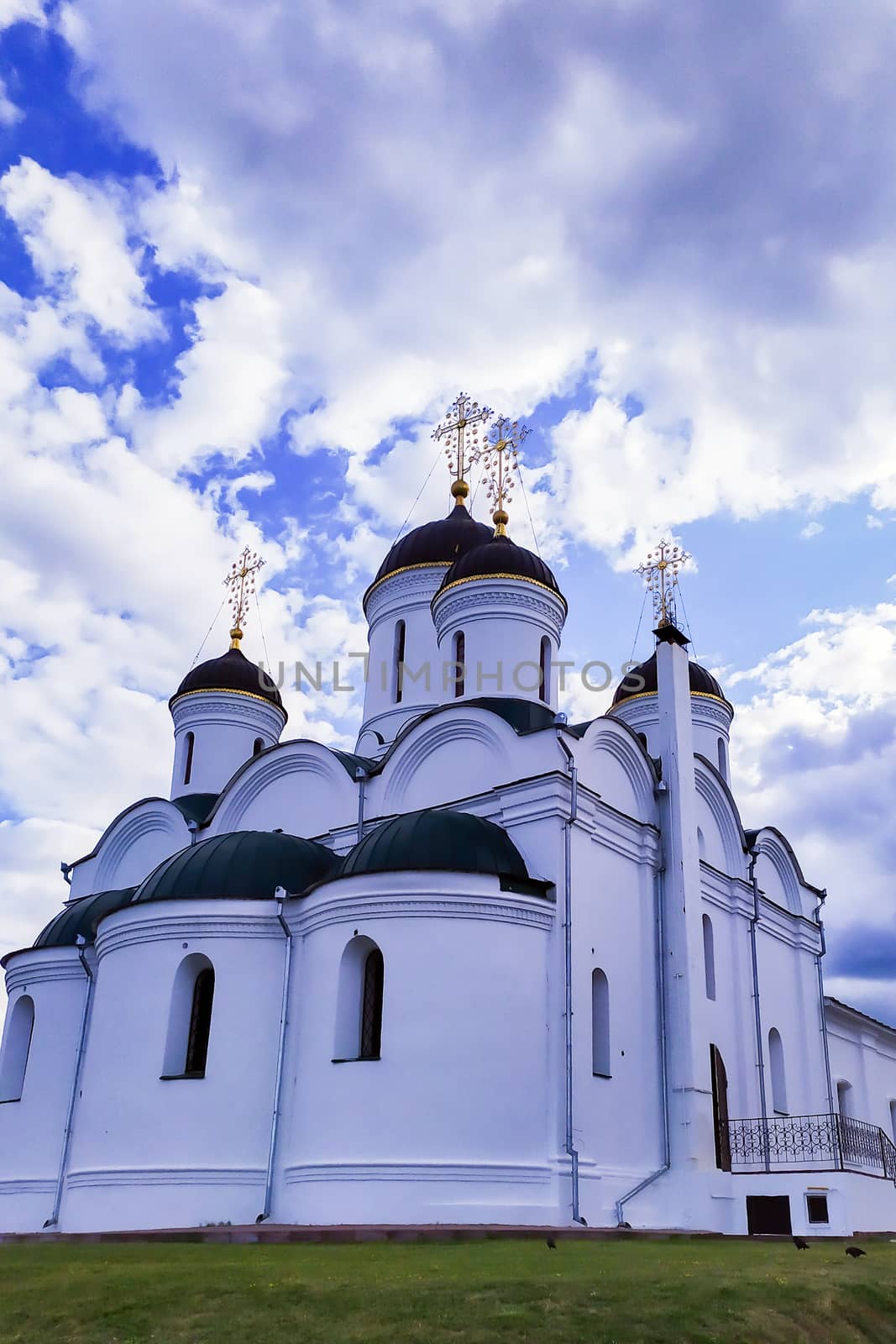 Ancient white Stone Orthodox Church with dark domes and Golden crosses by bonilook