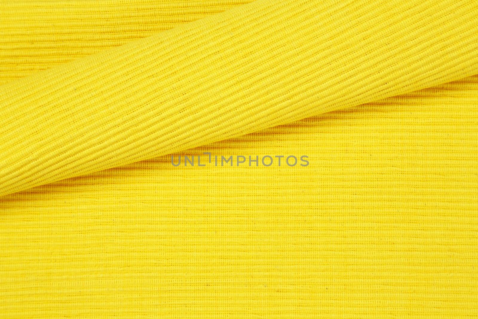 Detail of yellow woven cotton place mat - background, full frame