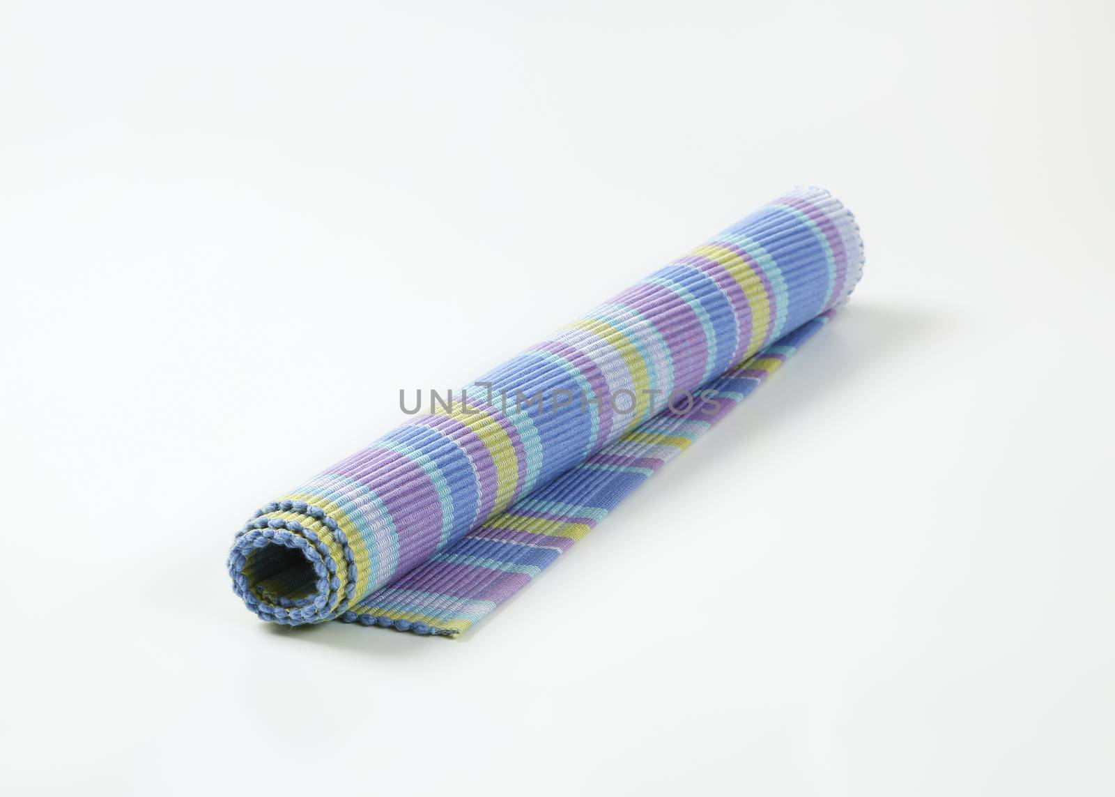 Colorful striped ribbed woven cotton place mat - rolled up