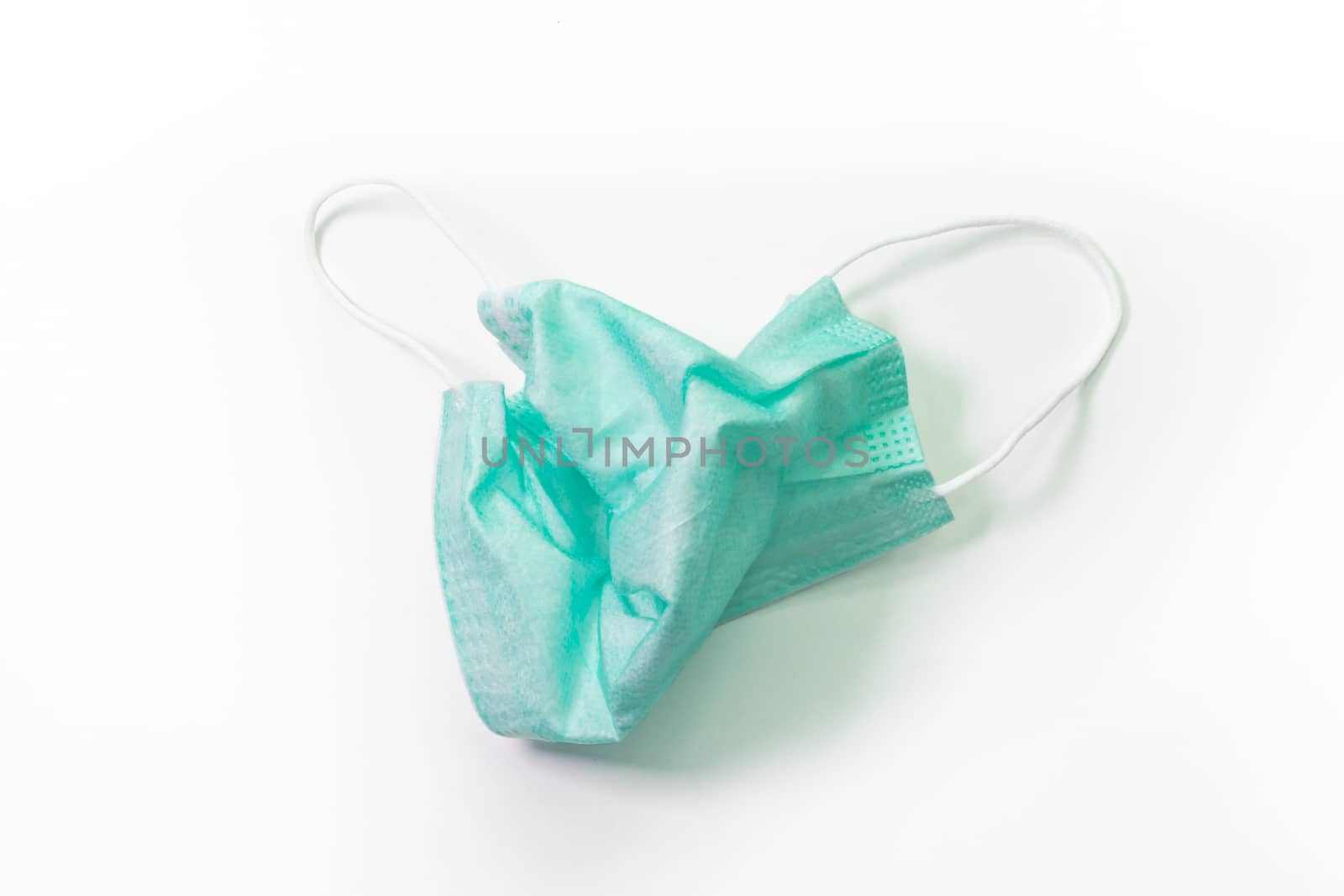 The close up of Used anti-viral protection mask on white background.