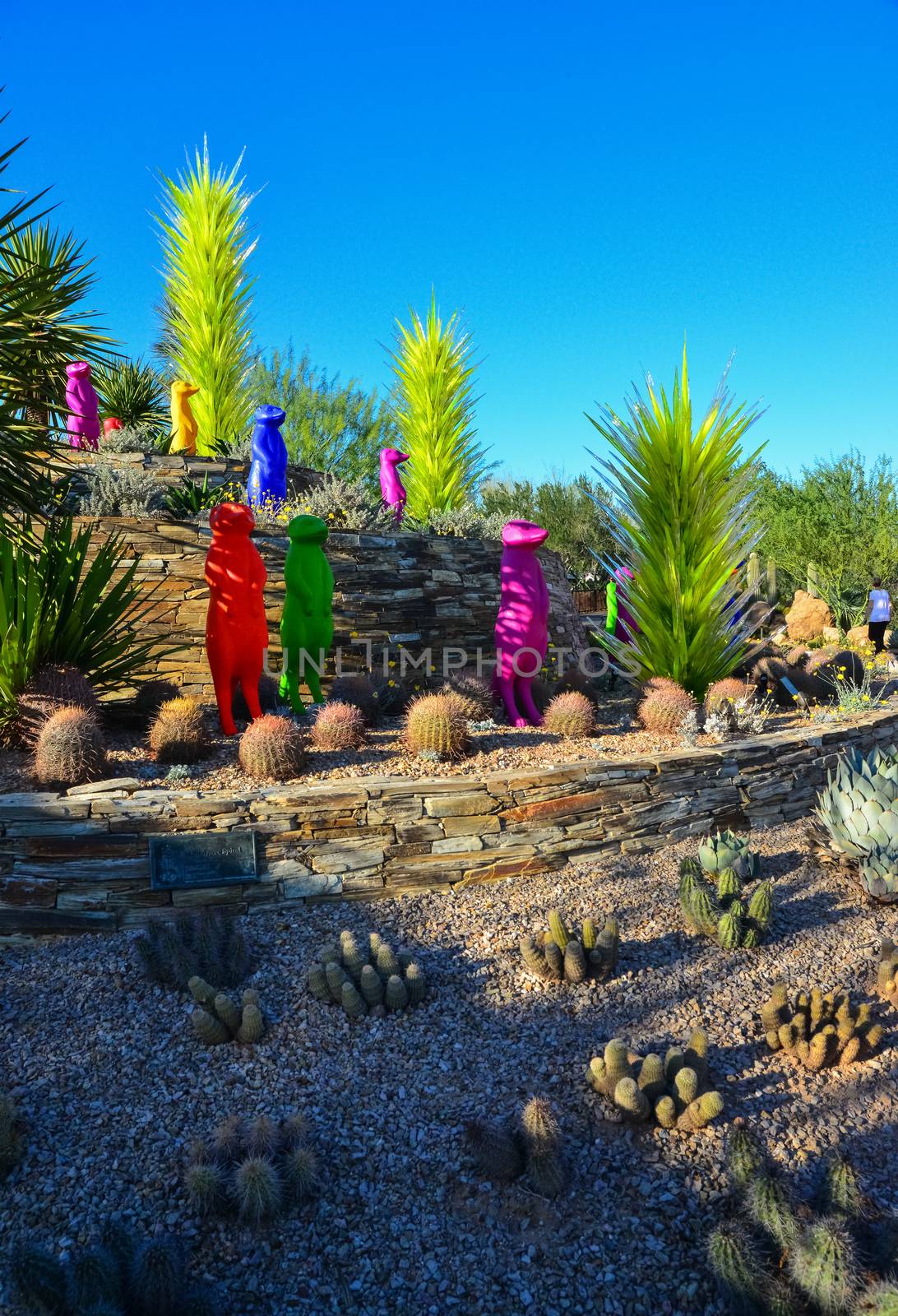 USA, PHENIX, ARIZONA- NOVEMBER 17, 2019: multi-colored plastic animal figures among cacti of different species in the botanical garden of the Phoenix, Arizona