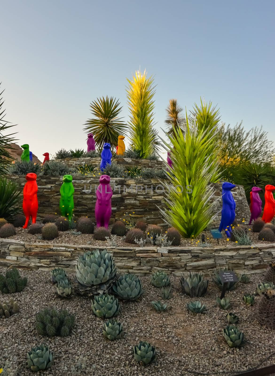 USA, PHENIX, ARIZONA- NOVEMBER 17, 2019: multi-colored plastic animal figures among cacti of different species in the botanical garden of the Phoenix, Arizona