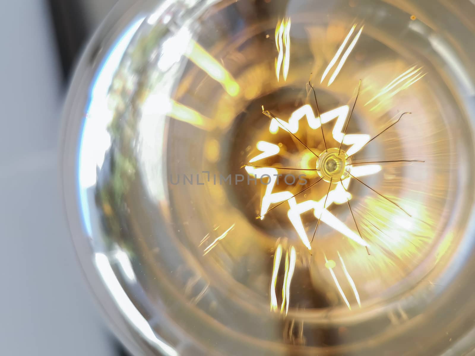 Electricity current inside a retro crystal clear light bulb.