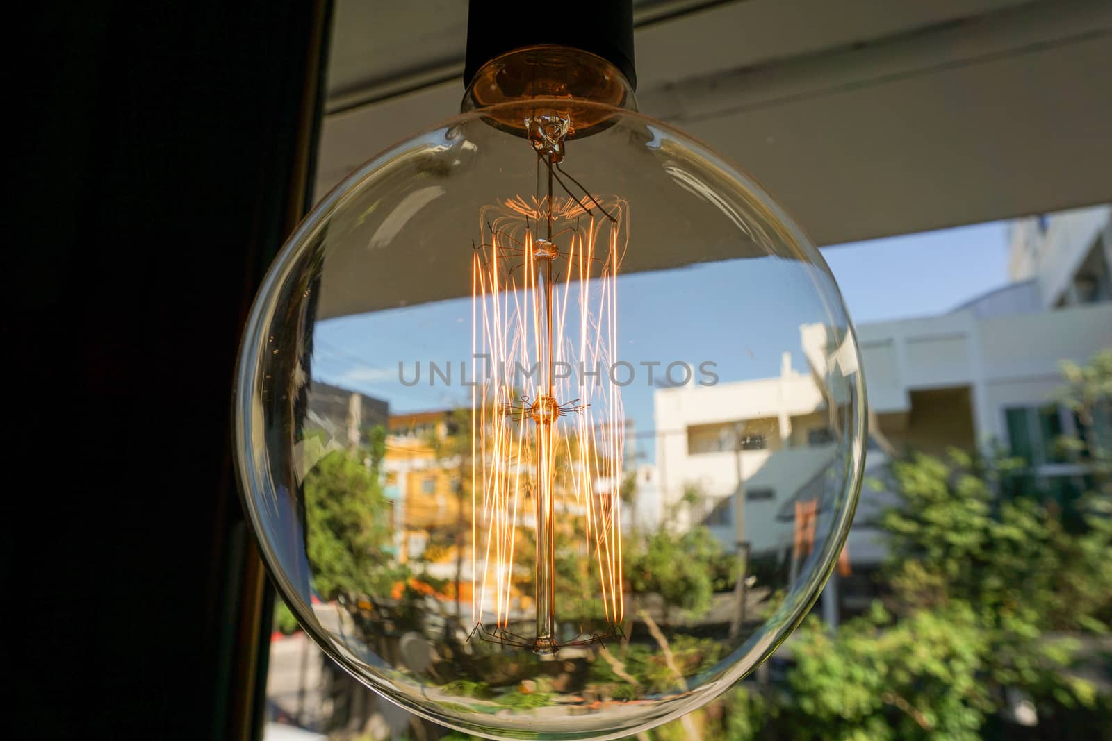 Electricity current inside a retro crystal clear light bulb.