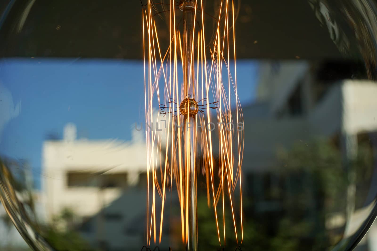 Electricity current inside a retro crystal clear light bulb.