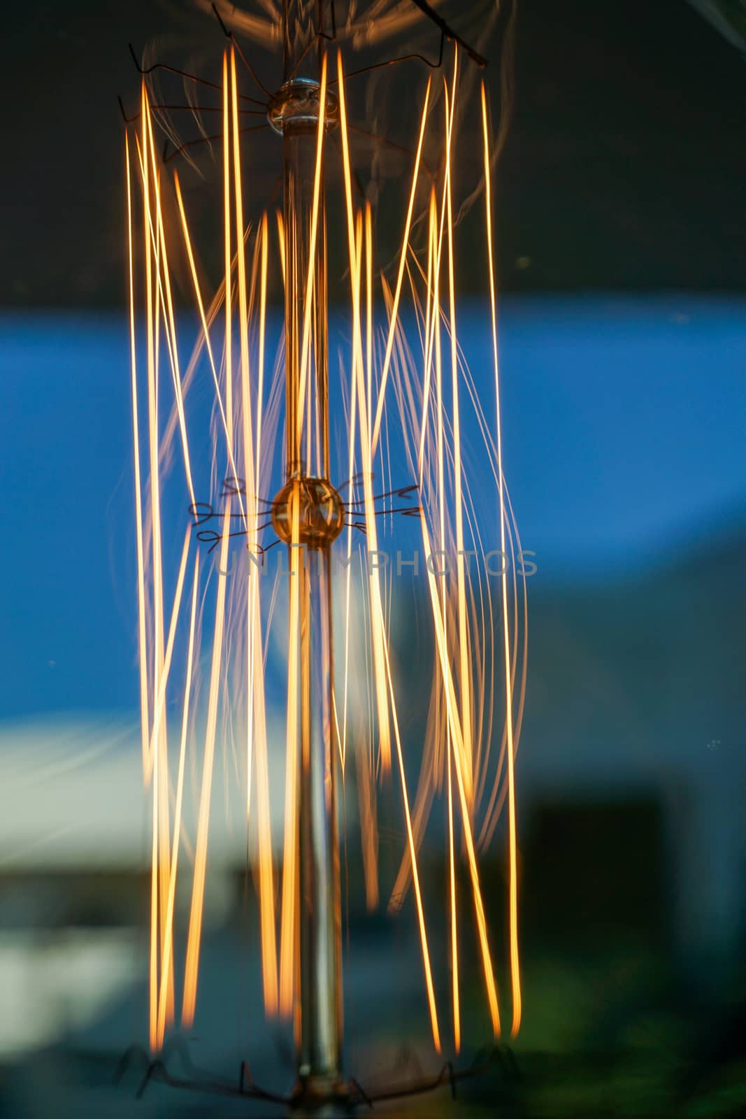 Electricity current inside a retro crystal clear light bulb.