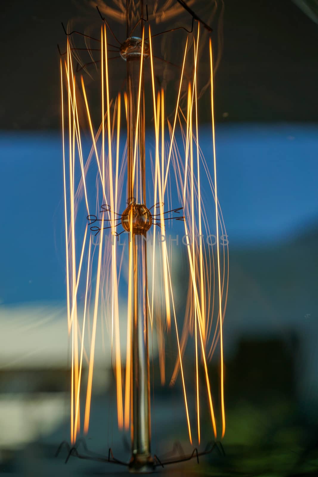 Electricity current inside a retro crystal clear light bulb.