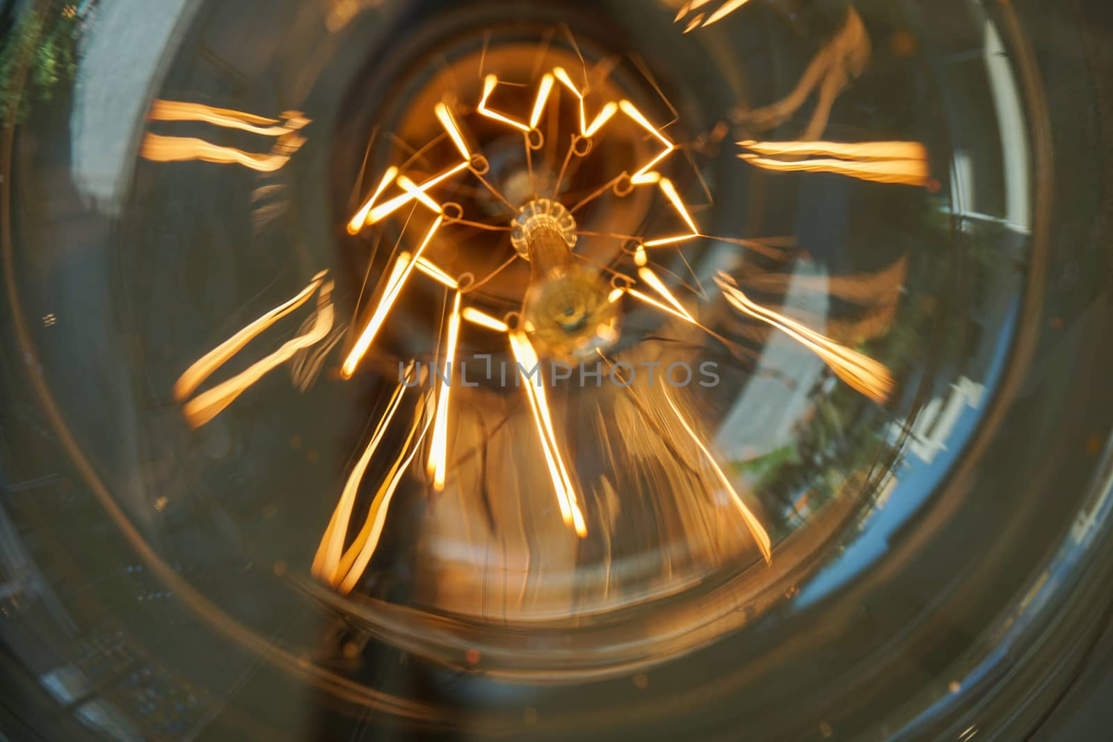 Electricity current inside a retro crystal clear light bulb.