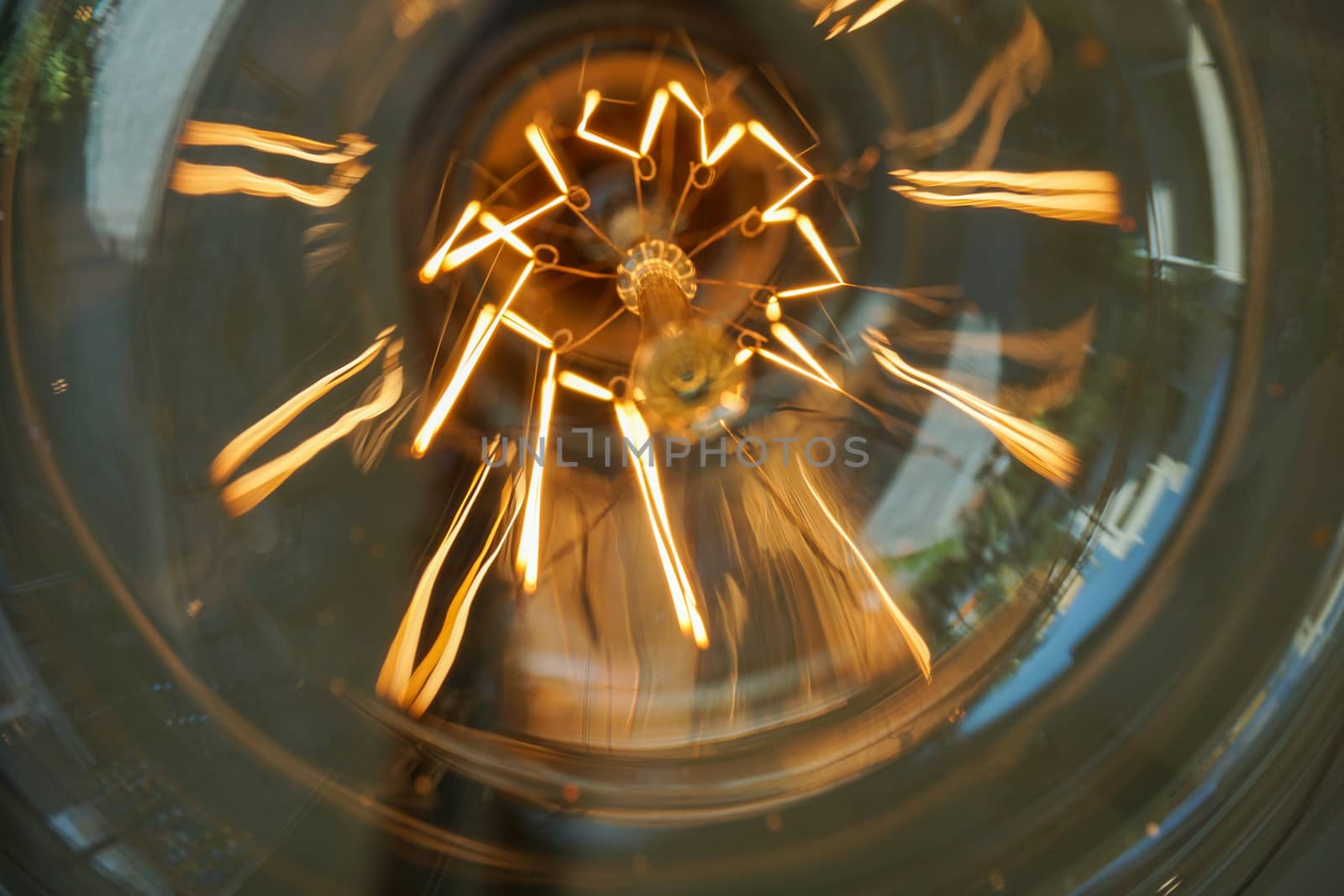 Electricity current inside a retro crystal clear light bulb.