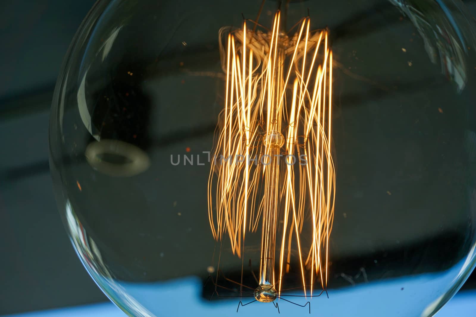 Electricity current inside a retro crystal clear light bulb.