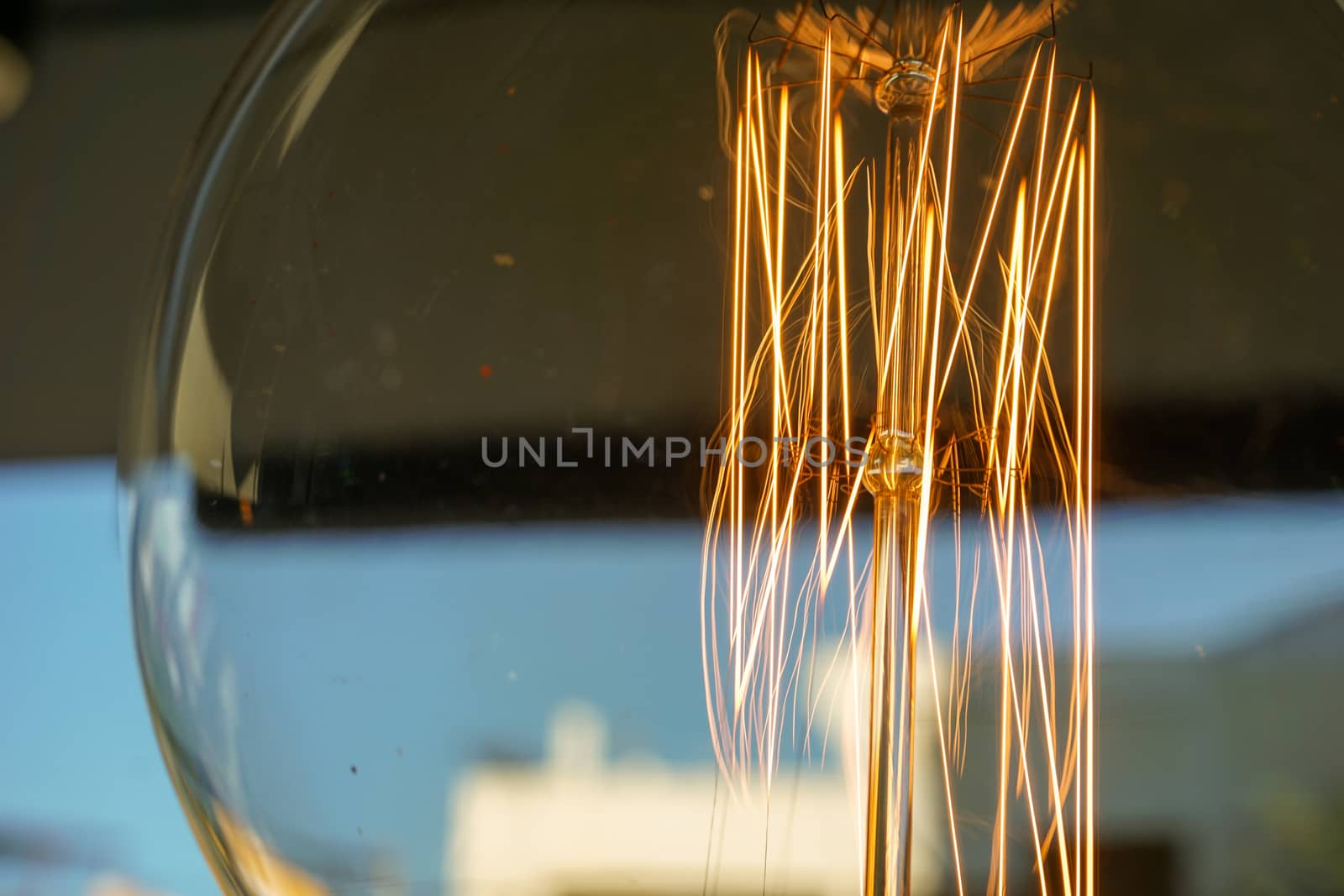 Electricity current inside a retro crystal clear light bulb.