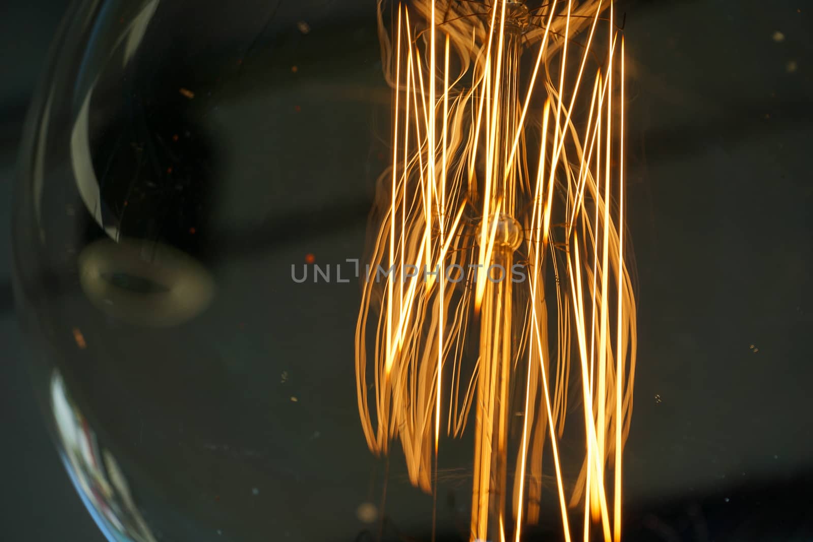 Electricity current inside a retro crystal clear light bulb.