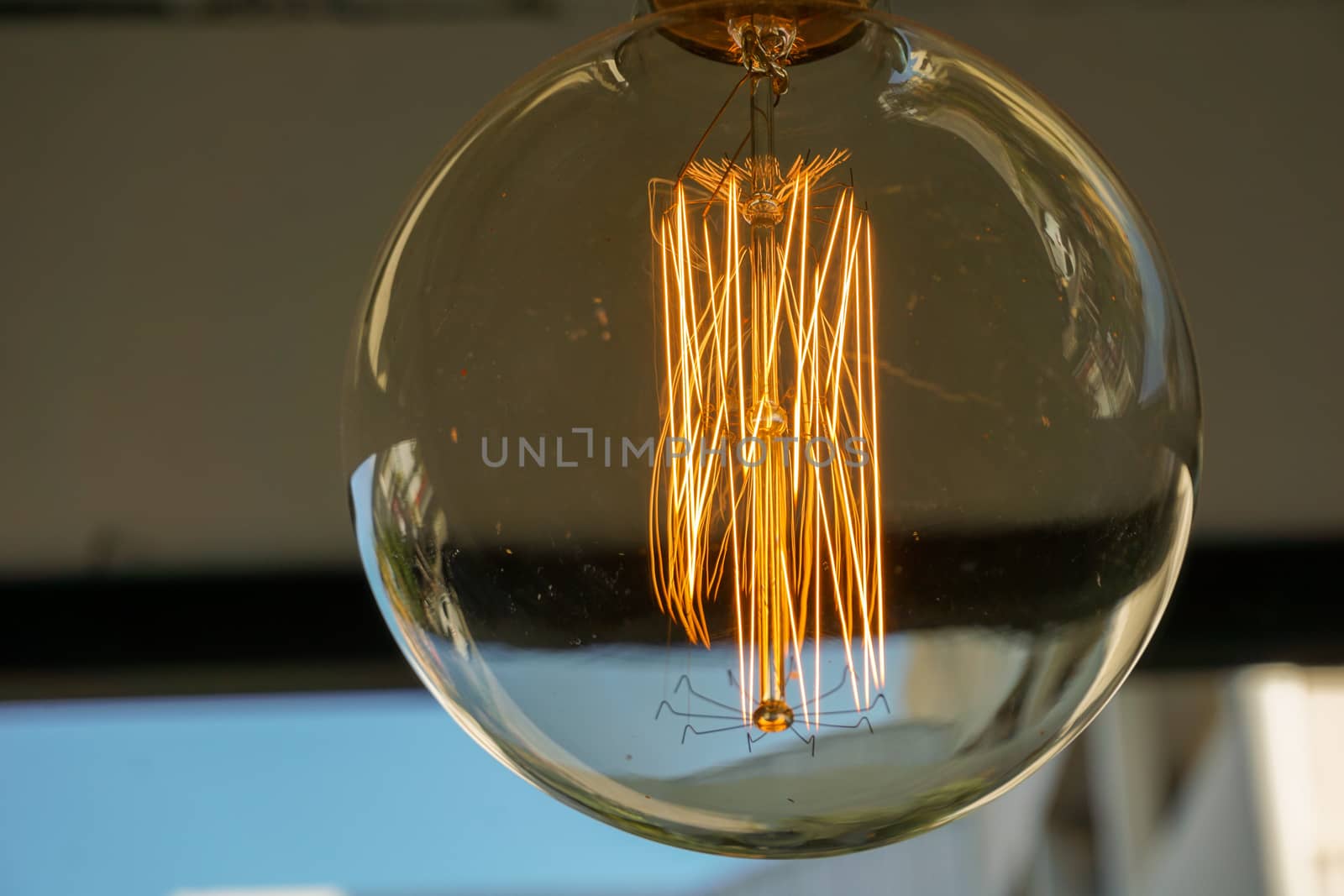 Electricity current inside a retro crystal clear light bulb.