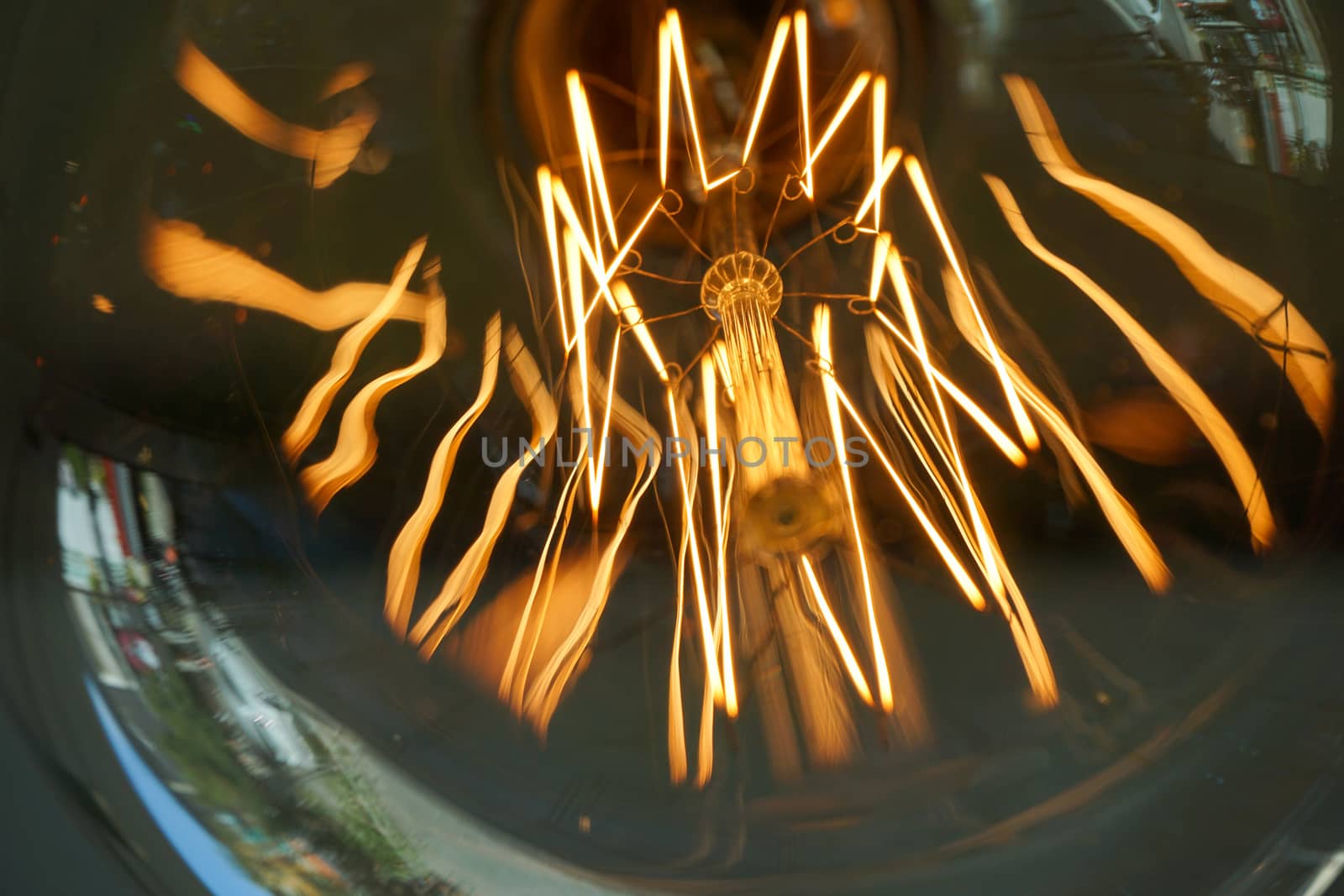 Electricity current inside a retro crystal clear light bulb.